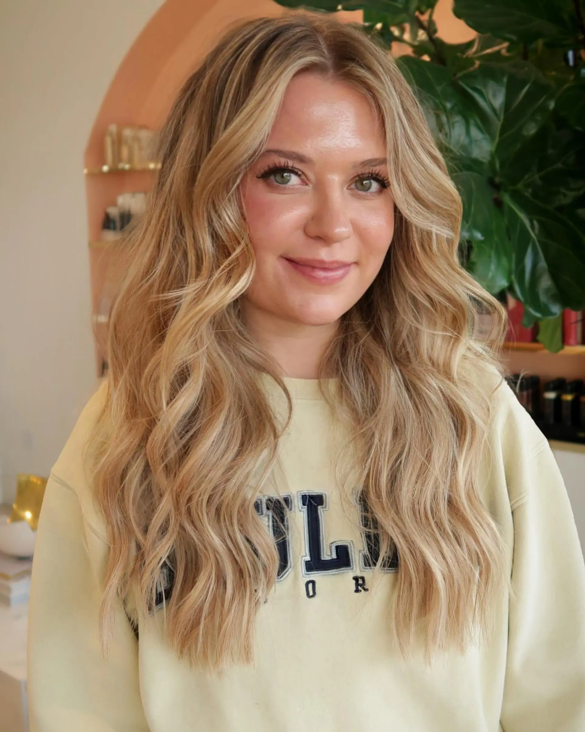 Long golden blonde hair styled in soft, loose waves with face-framing layers. 1