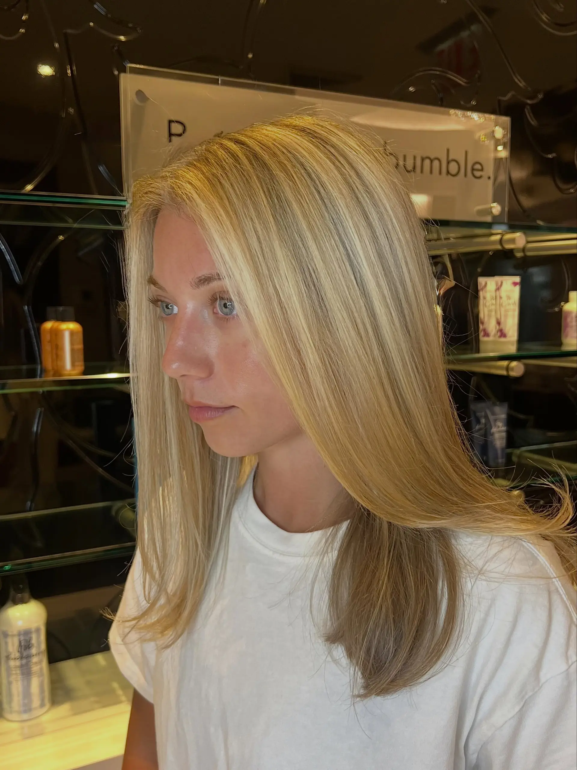 A sleek, smooth blowout featuring multi-tonal bright blonde highlights over natural undertones. 1