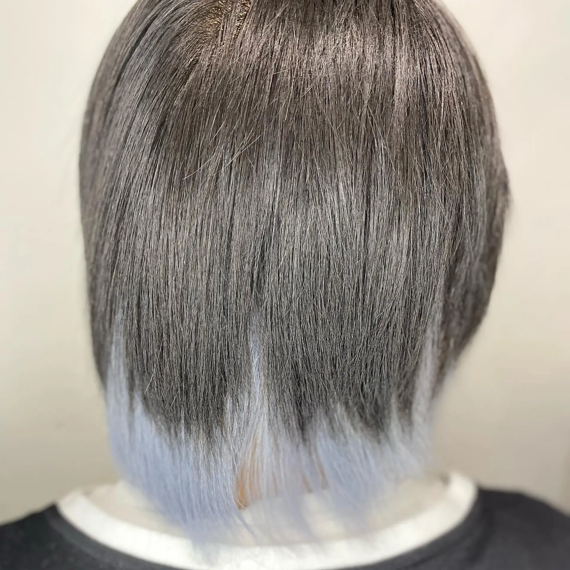 A medium-length straight bob with black hair and gray/silver peekaboo highlights. 2