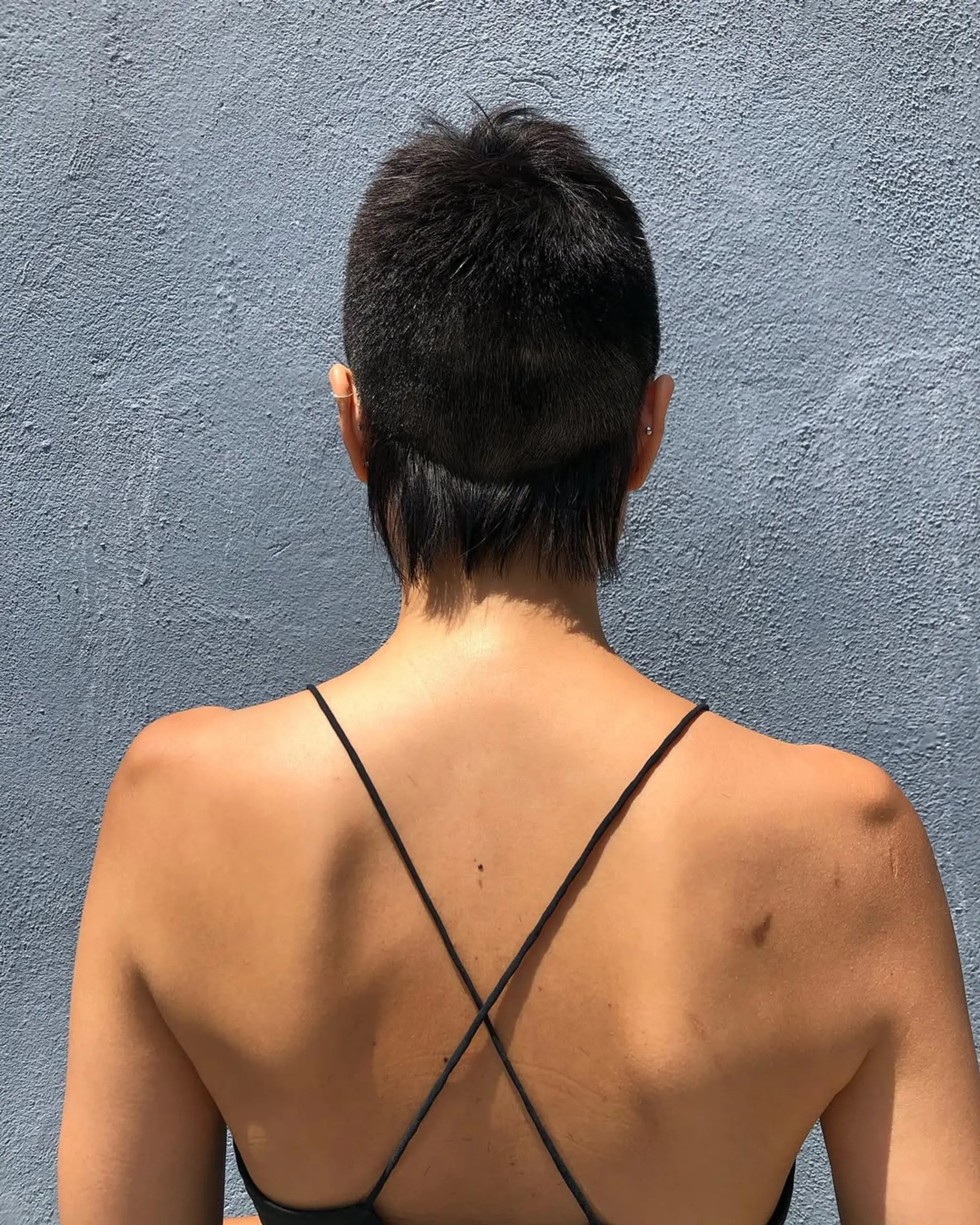 A modern mullet with an undercut, featuring a textured top and a long nape with a side fade. 2