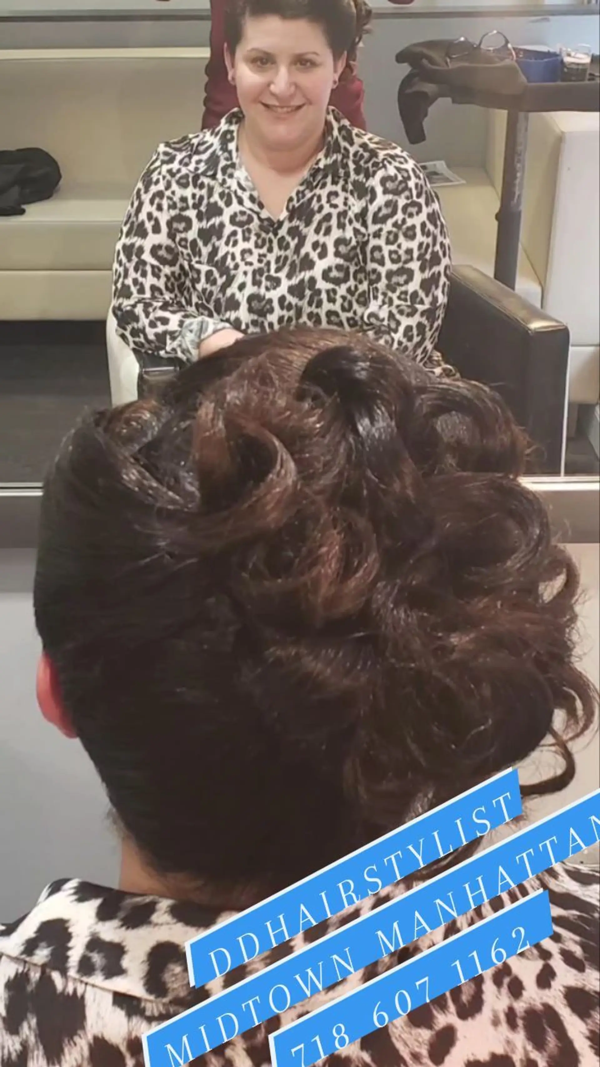A sophisticated formal updo styled with voluminous pinned curls creating a textured, elegant silhouette at the back. 1