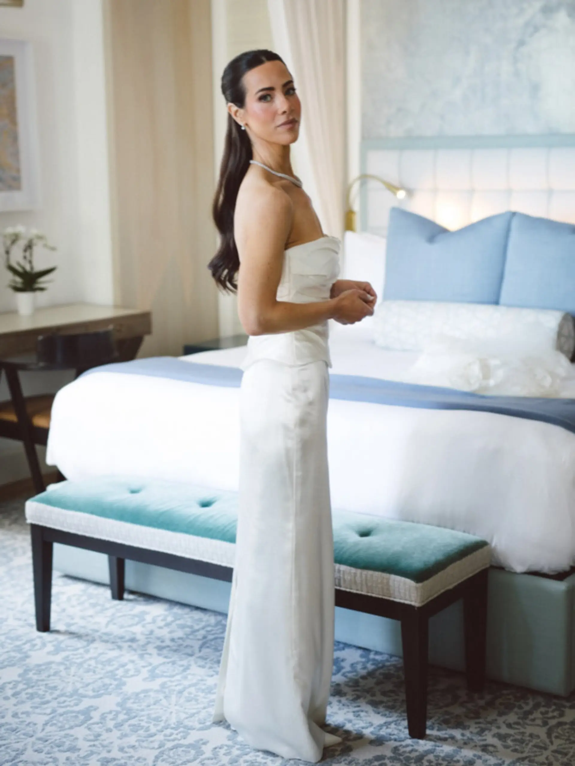 Sleek half-up ponytail with smooth crown and gentle waves extending down the back. 1