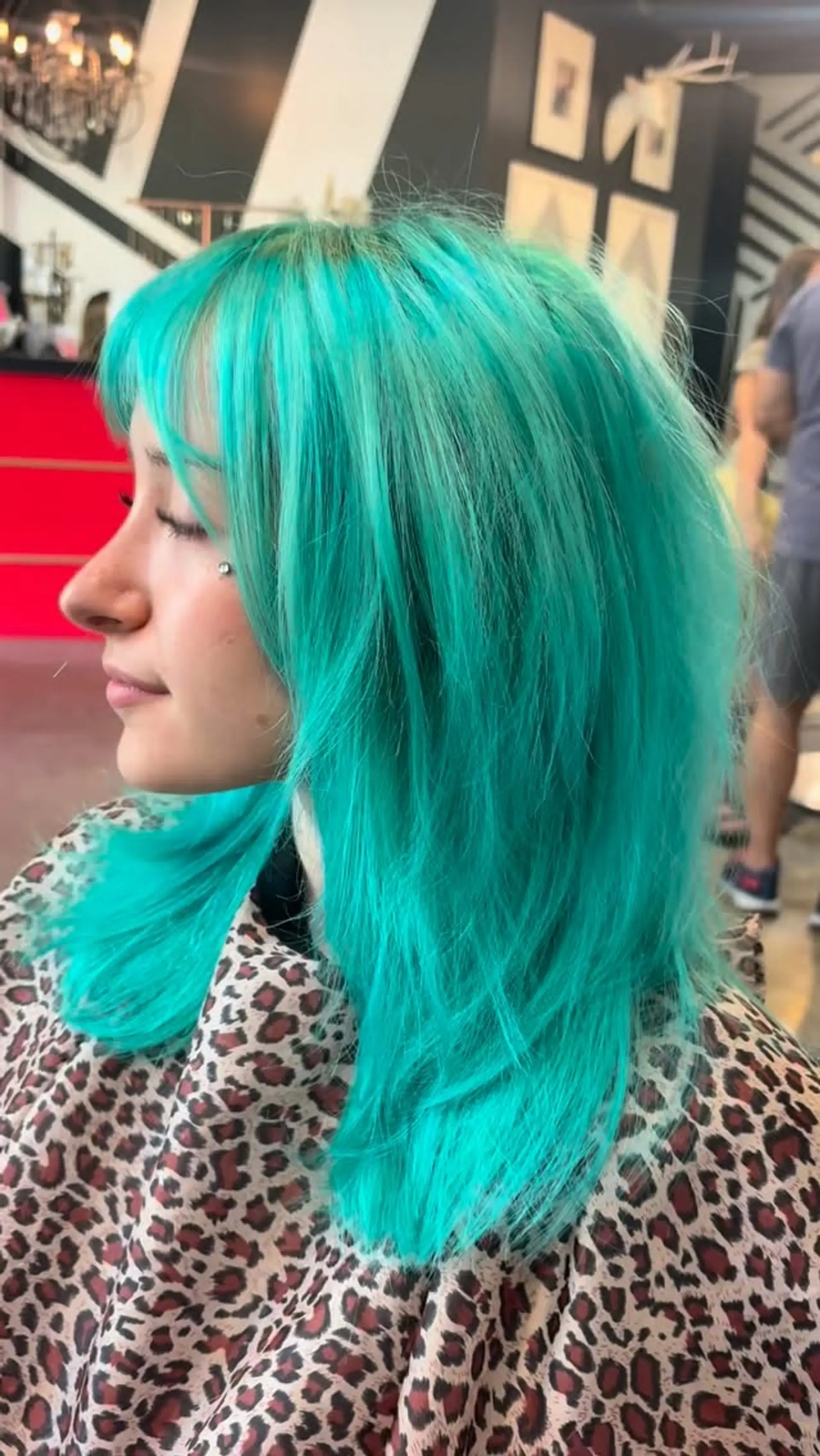 A vibrant teal layered wolf cut with wispy, face-framing fringe and feathered texture. 1