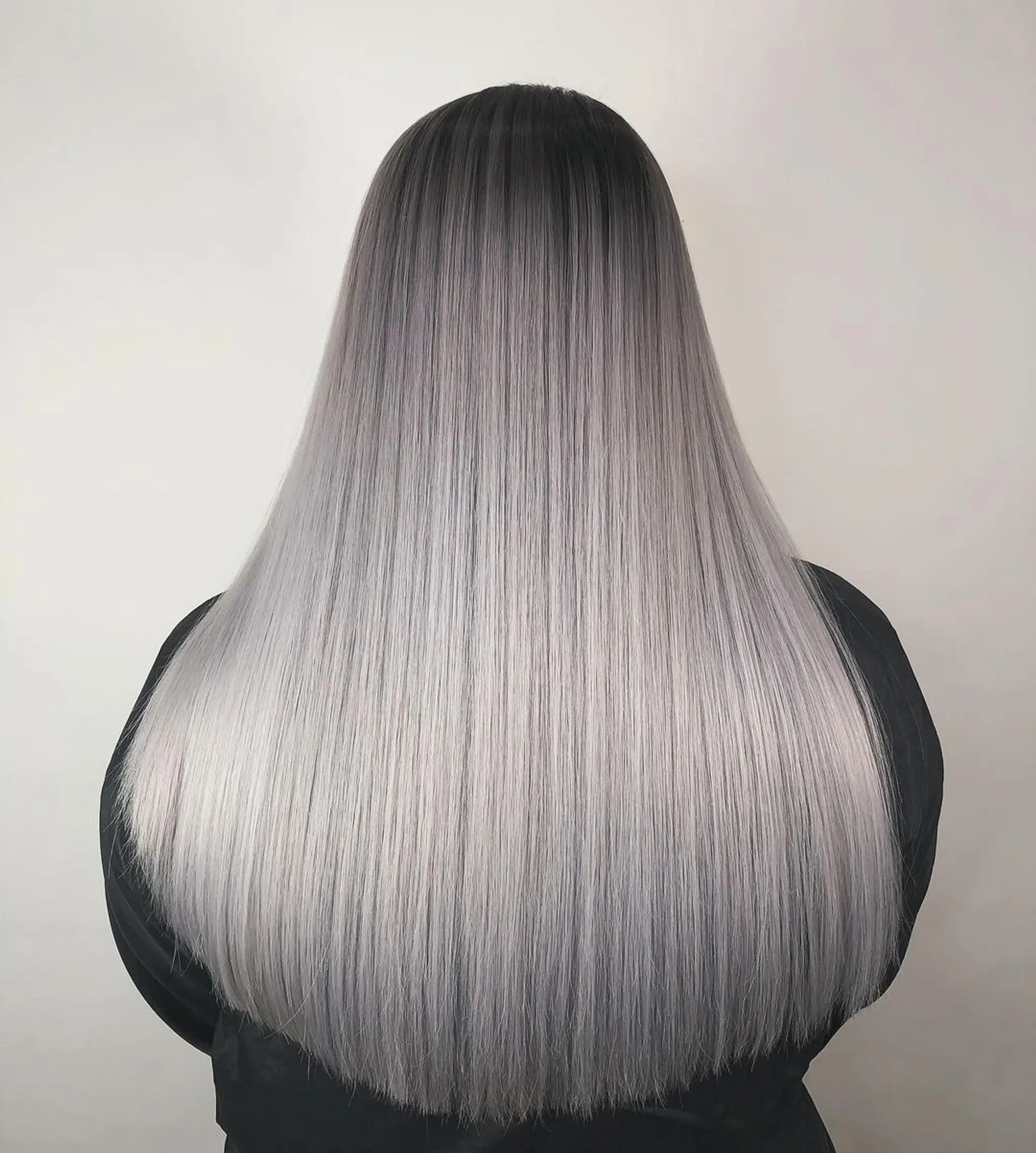 Very long, sleek, straight silver hair with dark roots creating an ombre effect.
Stylist - @xcellent_jason