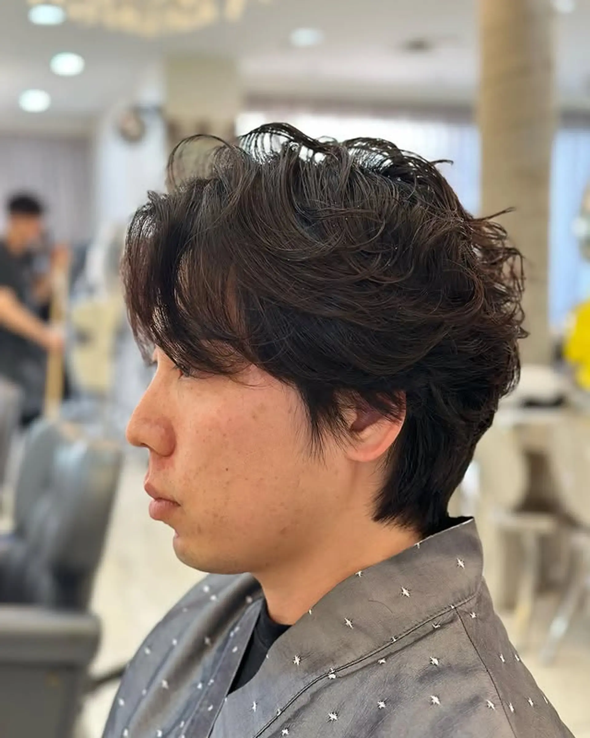 This hairstyle features soft layers and relaxed waves achieved with a perm. 1