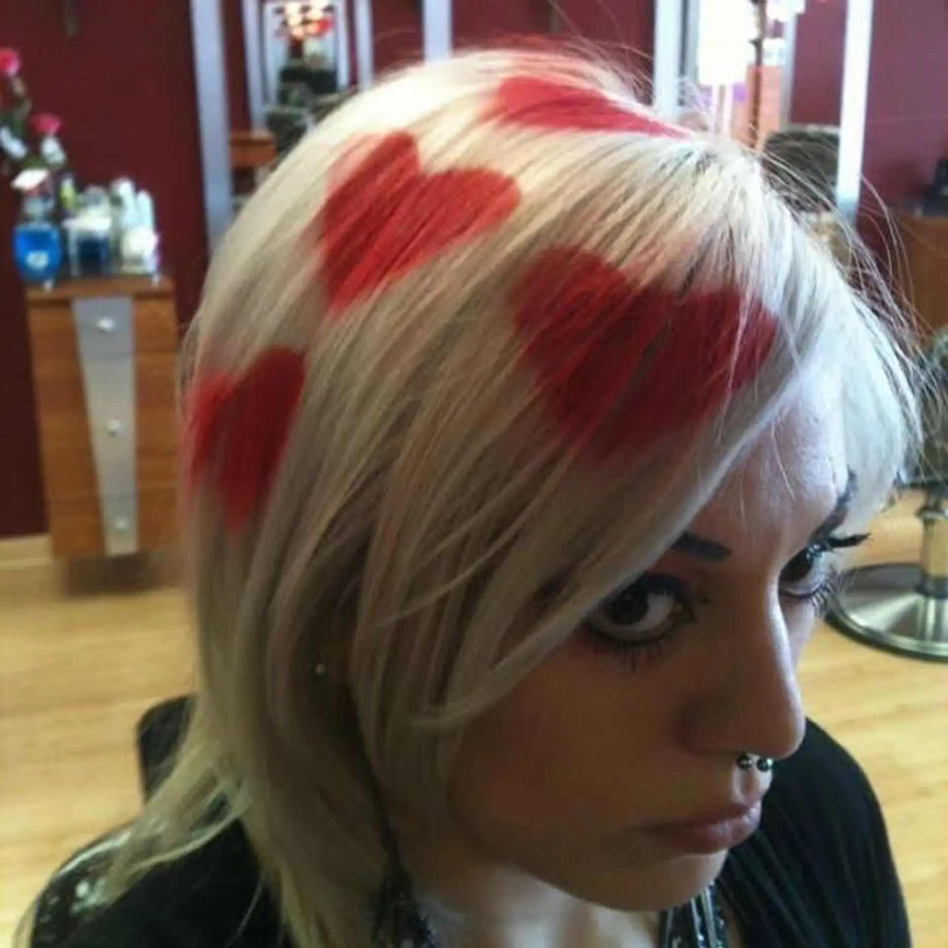 Medium length platinum blonde hair with a red heart print design. 1