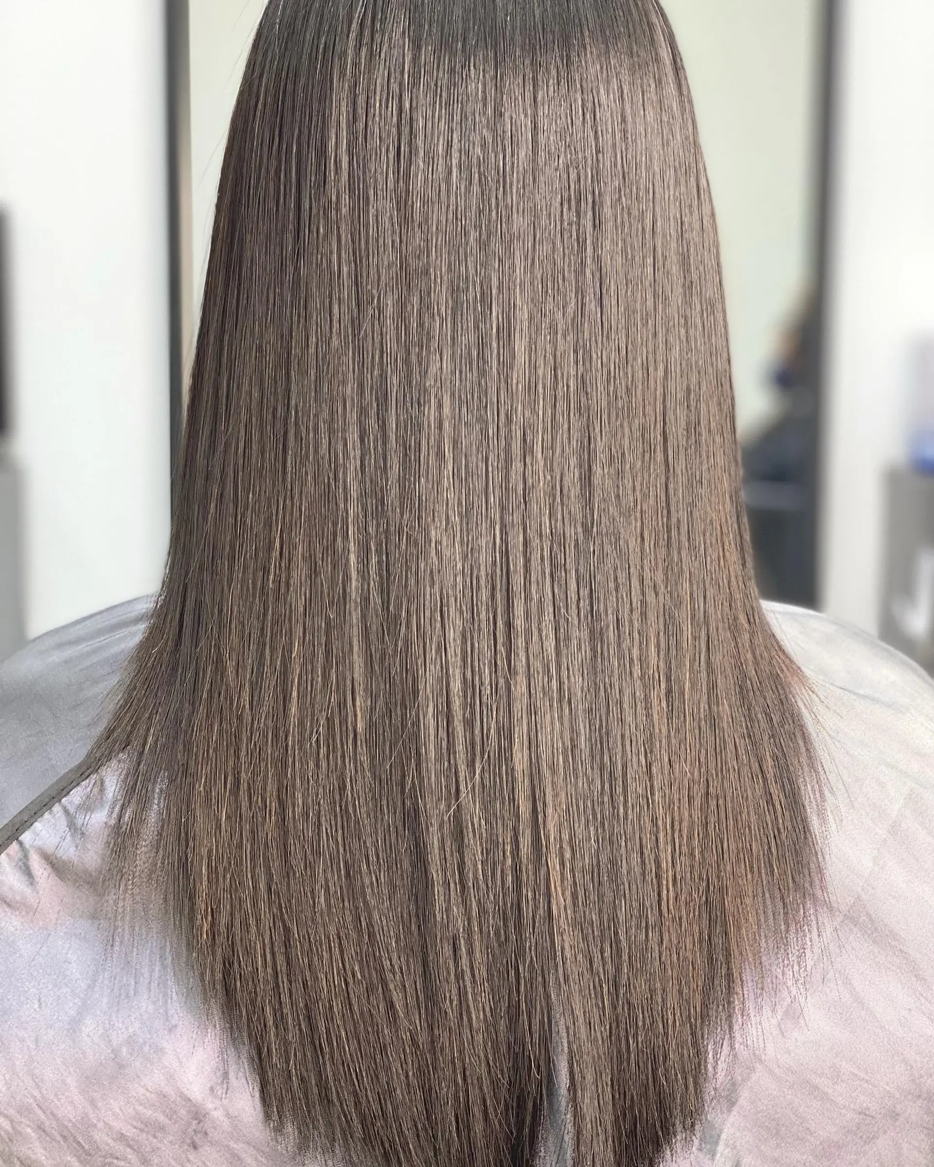 A long, straight hairstyle with a glossy finish. 1