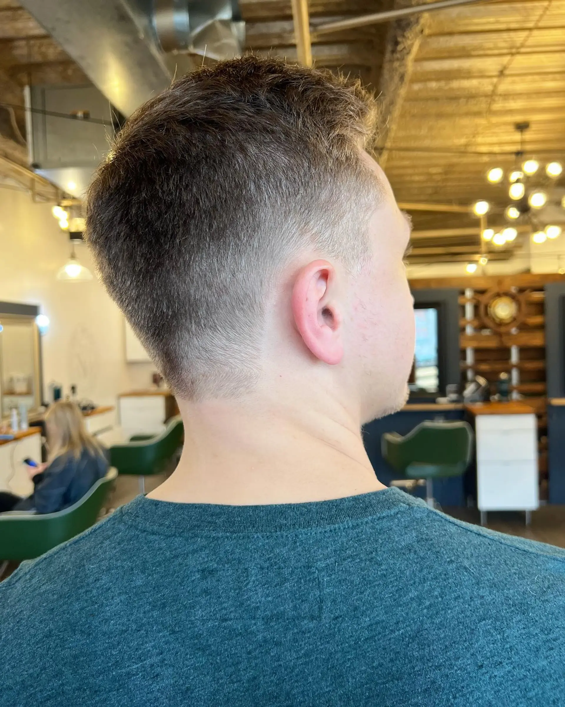 A clean short taper fade clipper cut with textured length on top. 1