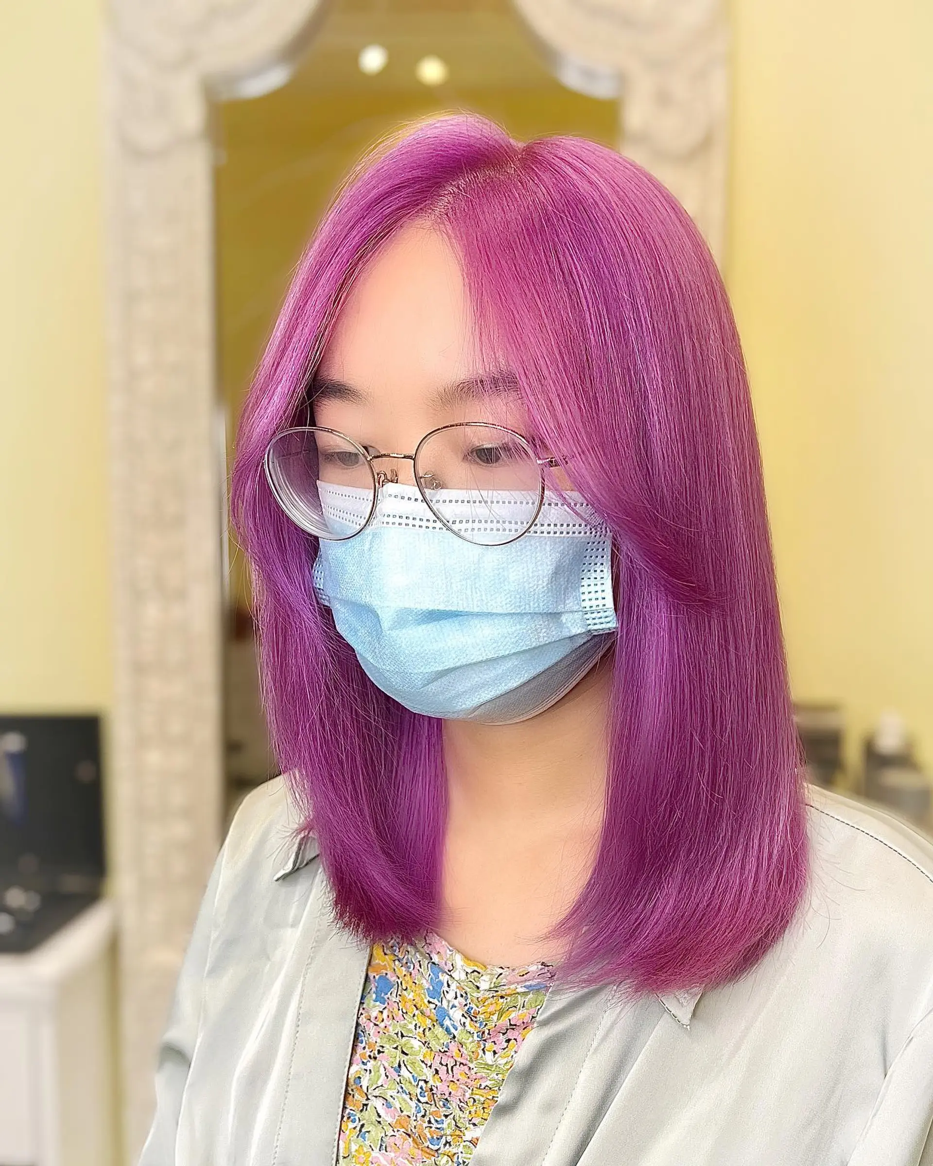 A medium-length long bob, also known as a lob, with a sleek and straight finish. The style features a center part and falls just below the shoulders. 1