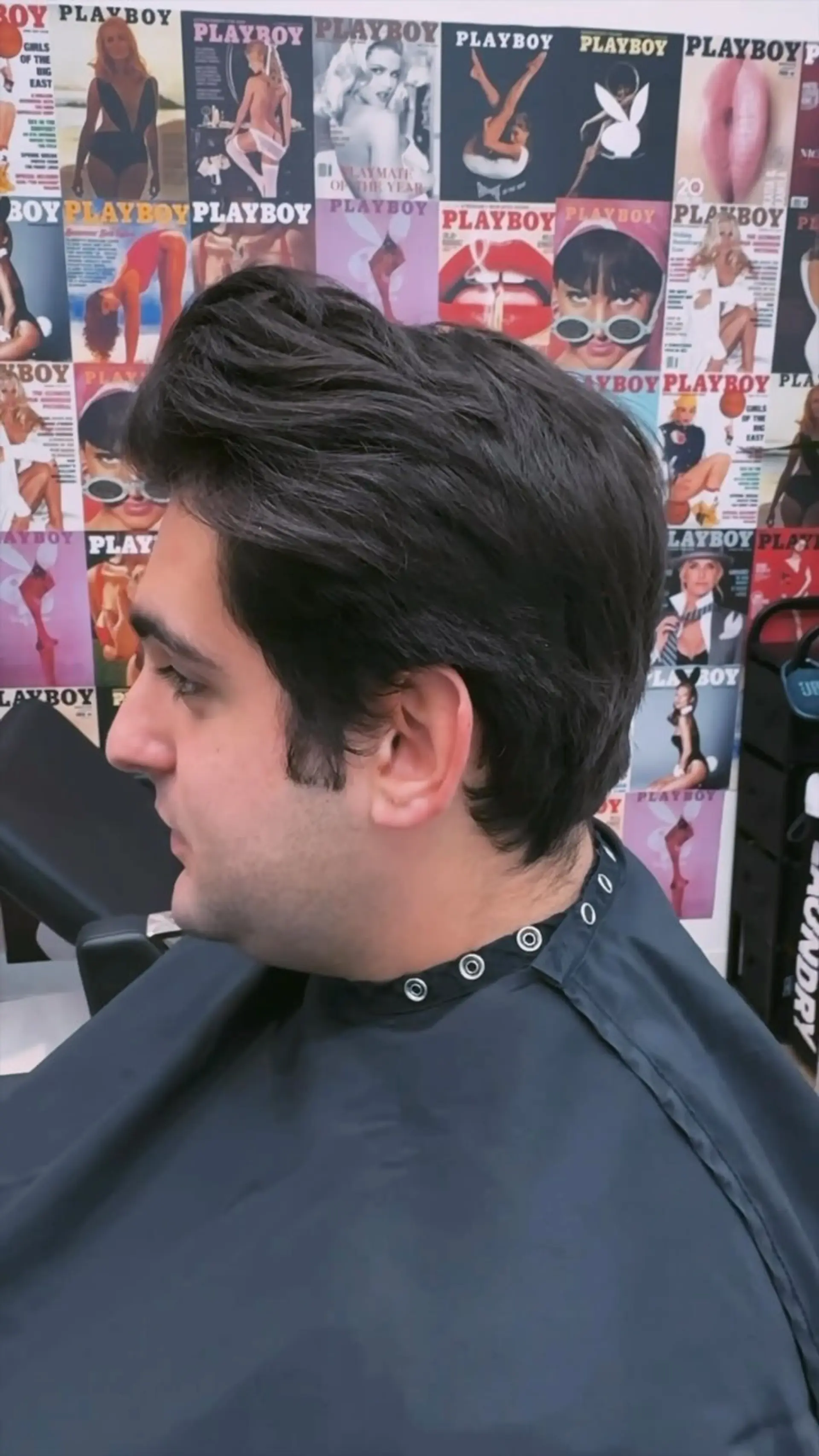 A classic scissor-cut men's style with clean, soft tapered edges around the ears and neck, and textured volume on top swept naturally back. 1