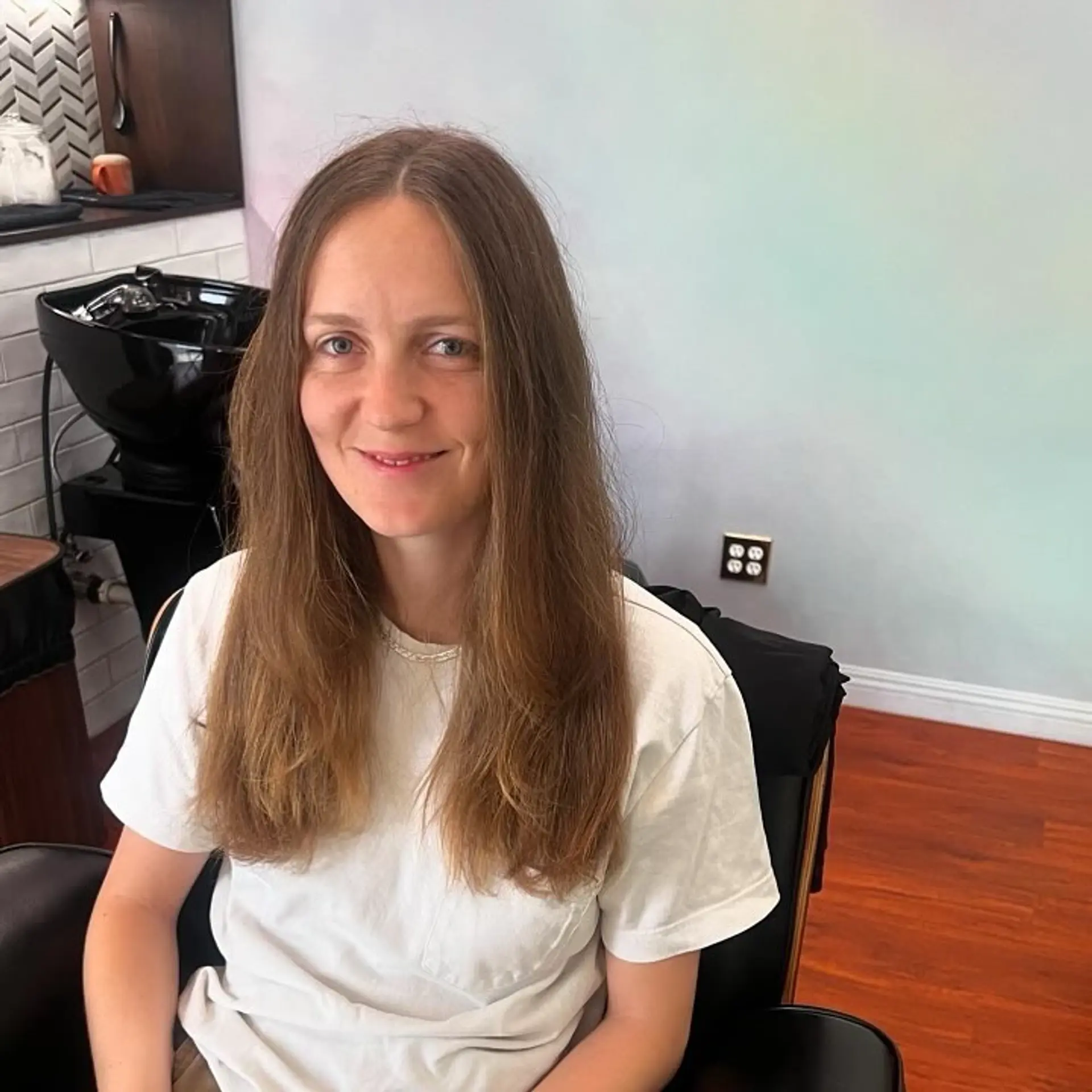 A long, natural brown haircut featuring a center part and soft, subtle layering at the ends. 1