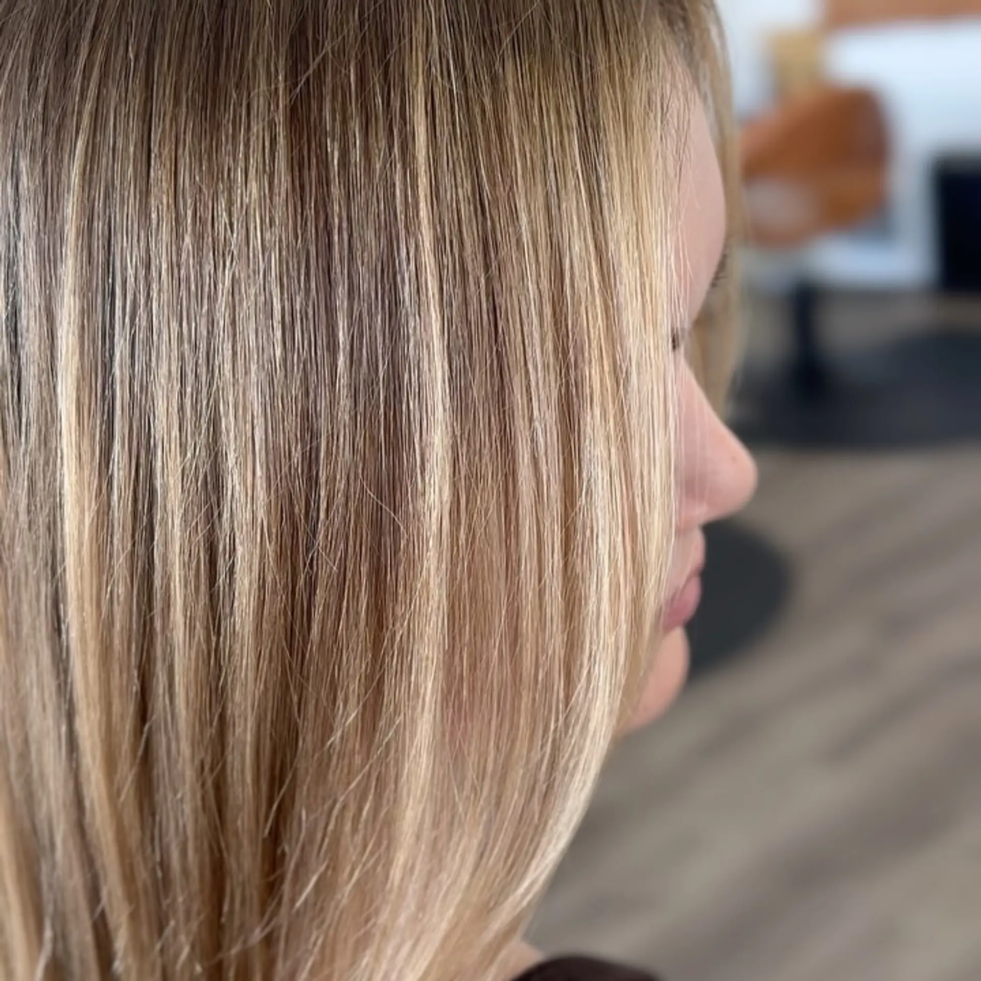 Straight, smooth medium-length hair featuring finely blended, multi-tonal dimensional blonde highlights over a natural base. 1