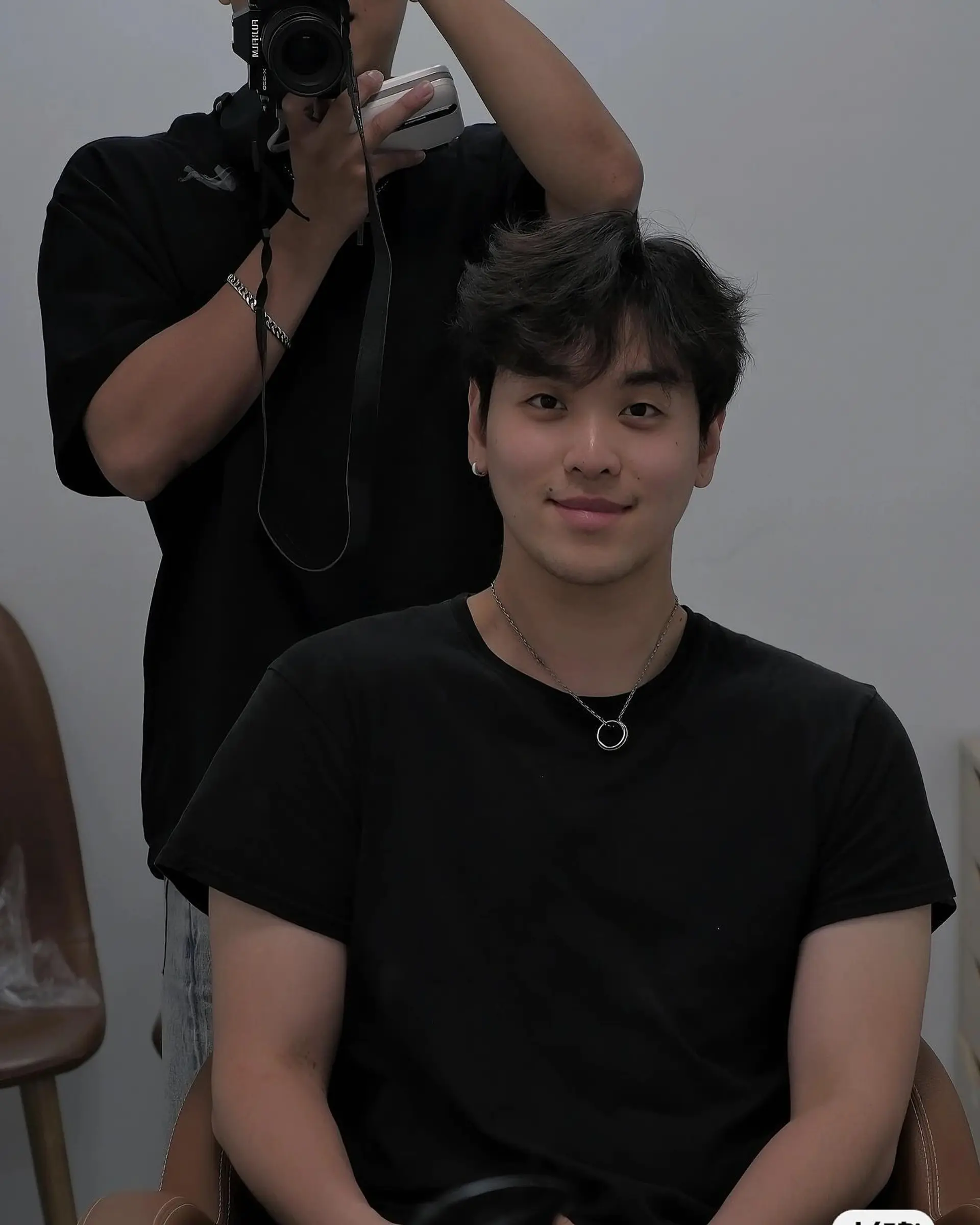 A short haircut featuring a textured top with tapered sides. 1