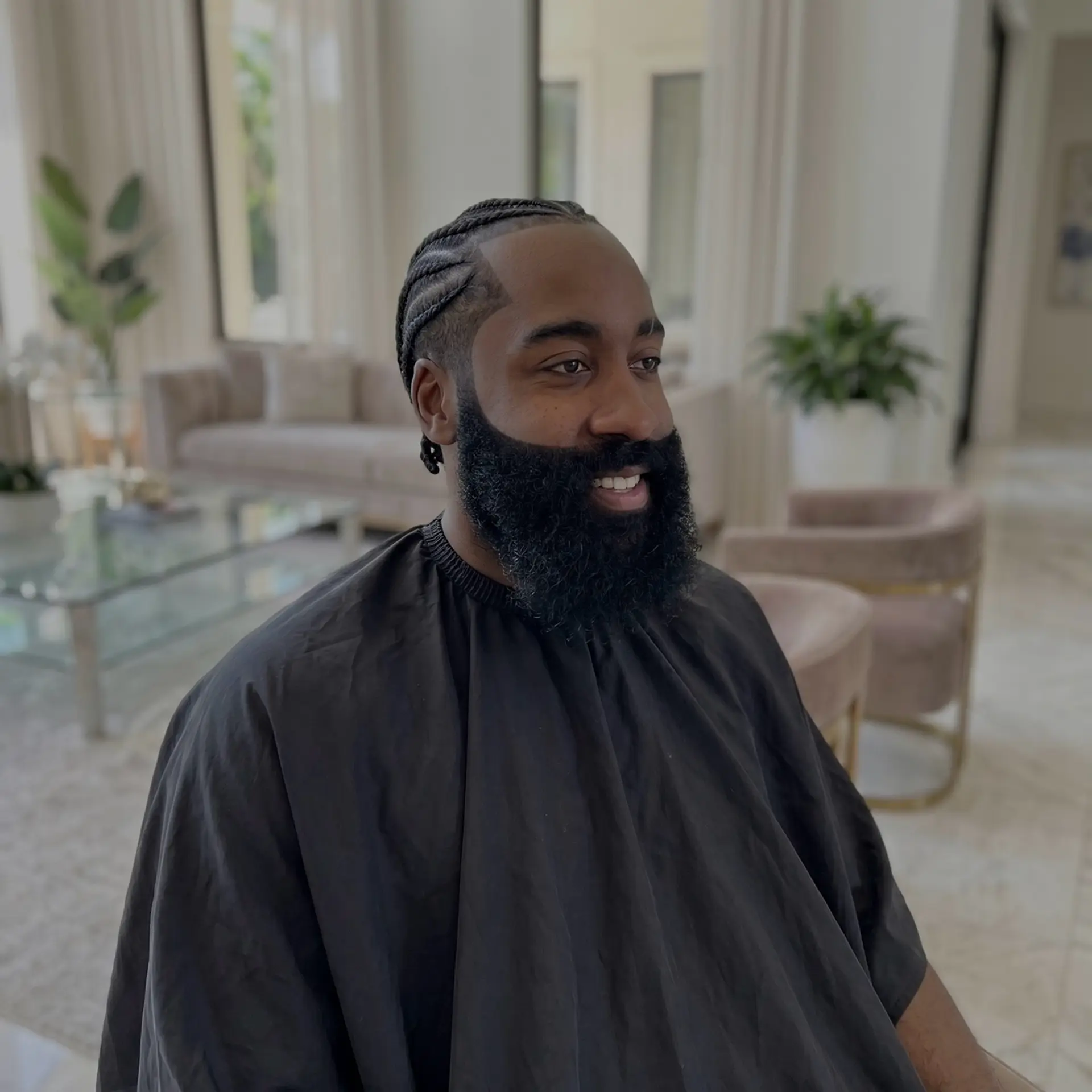 Neat cornrow braids paired with a sharp, crisp line up and a meticulously sculpted full beard. 1
