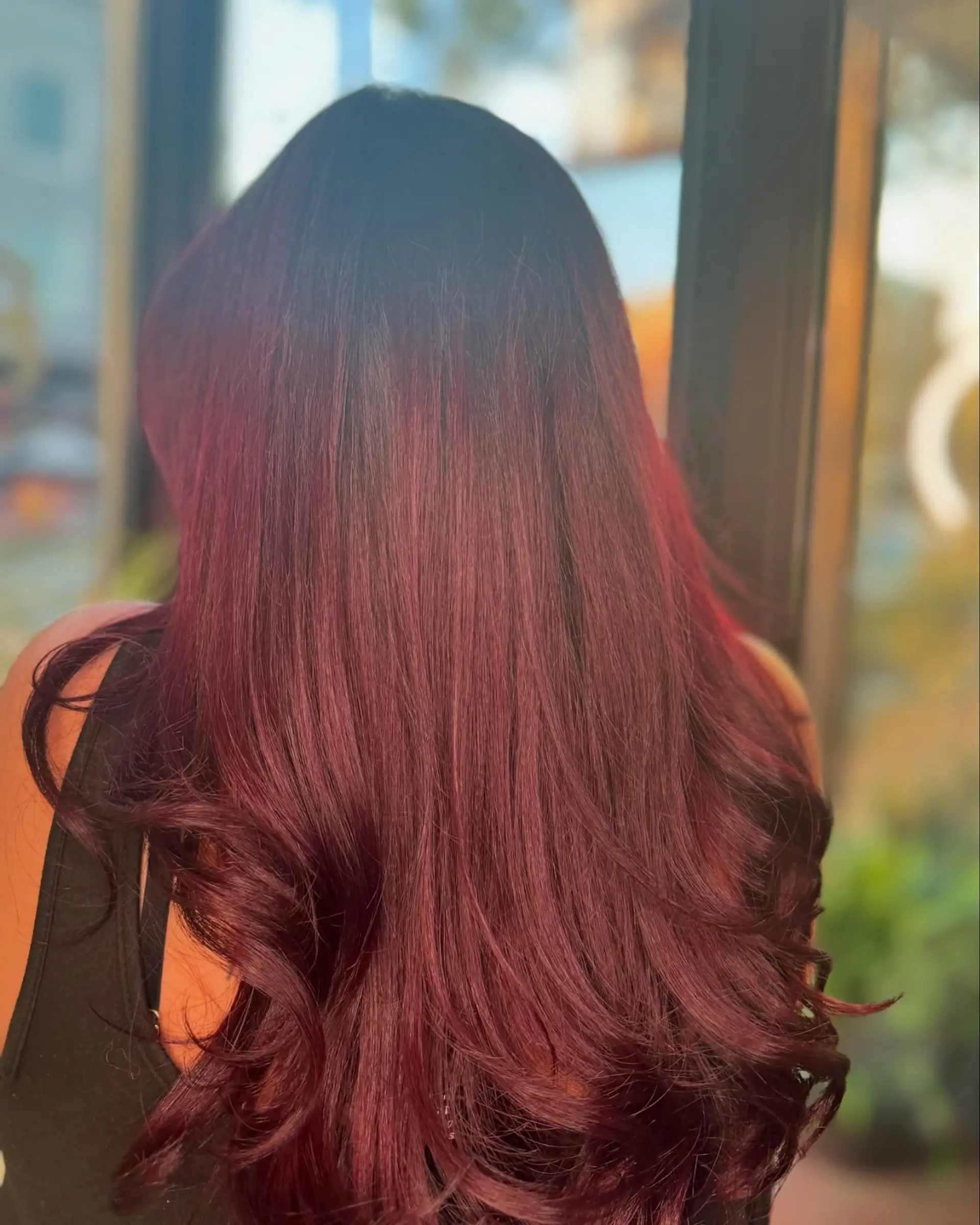 Long vibrant mahogany hair with smooth lengths and polished curved ends. 1