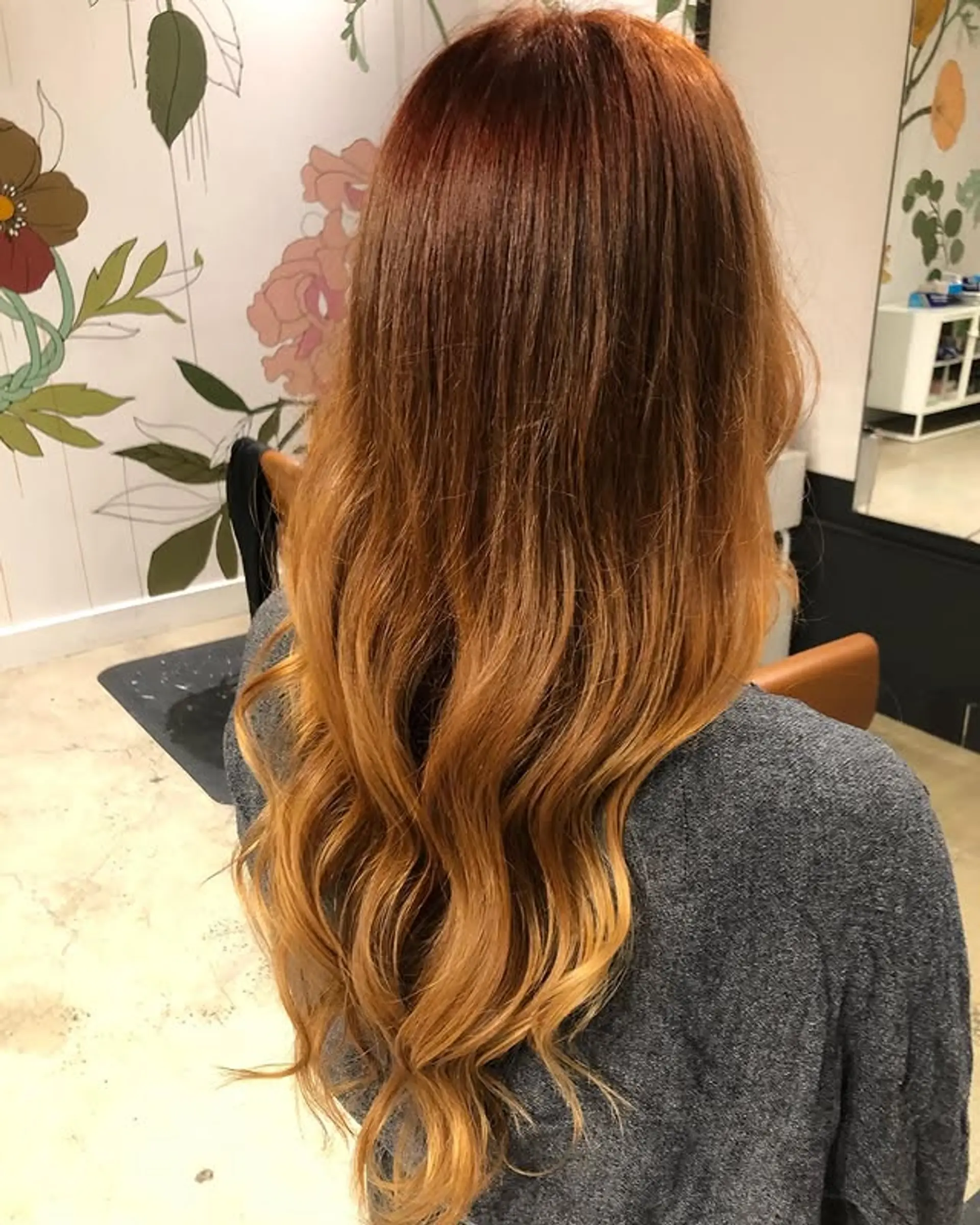 A layered, long wavy hairstyle with a copper ombre effect. 1