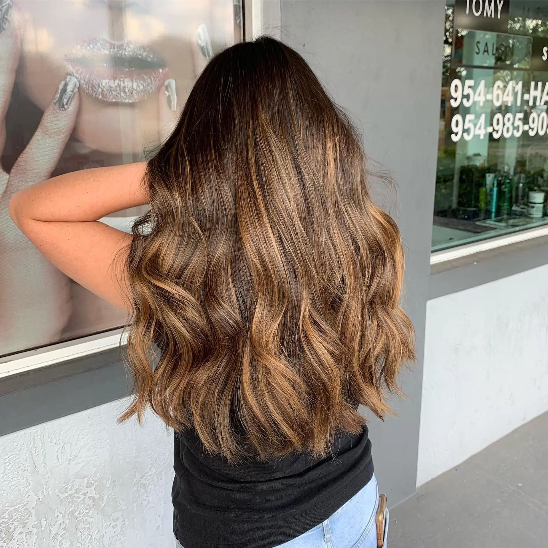 Long, layered wavy hair with a caramel balayage. 1