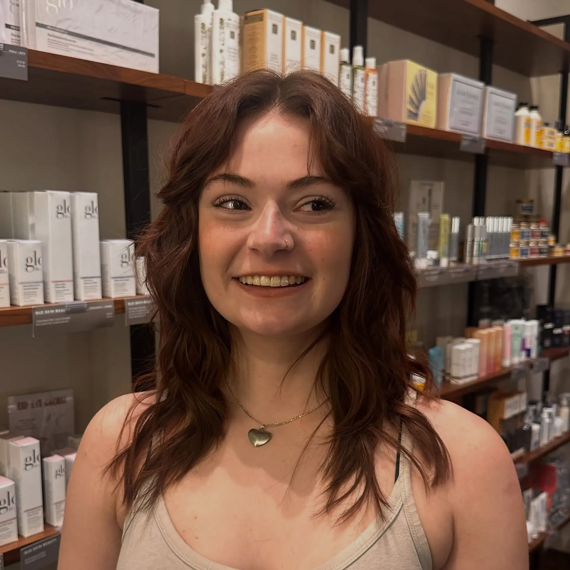 A medium-length modern shag cut featuring piecey, textured layers throughout and soft curtain bangs that accentuate the cheekbones, styled with natural wavy volume. 1