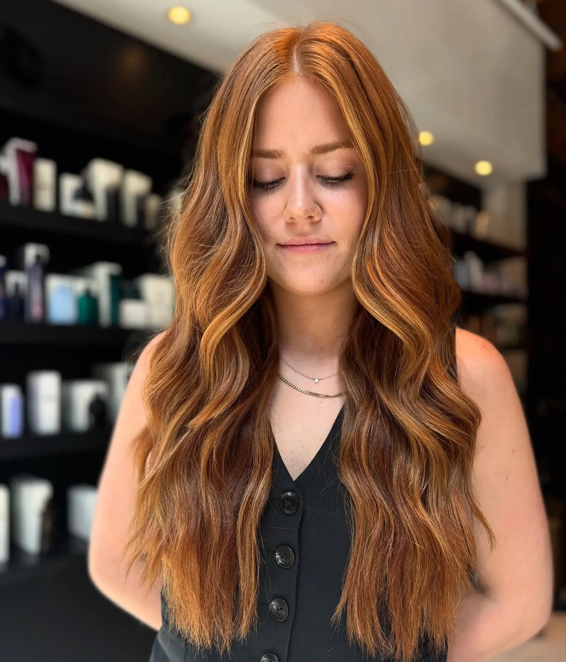 Long, warm copper hair styled in soft, effortless waves with lighter face-framing highlights. 1