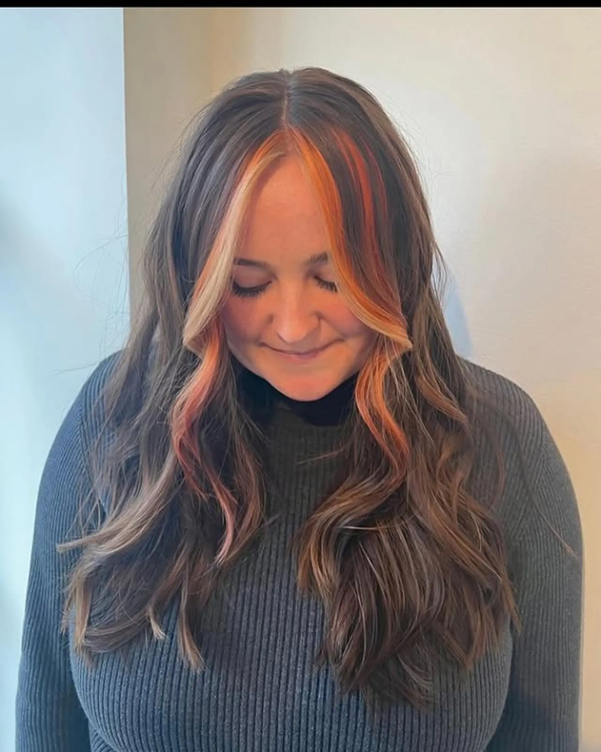 Long wavy hairstyle with face-framing blonde and orange highlights. 1