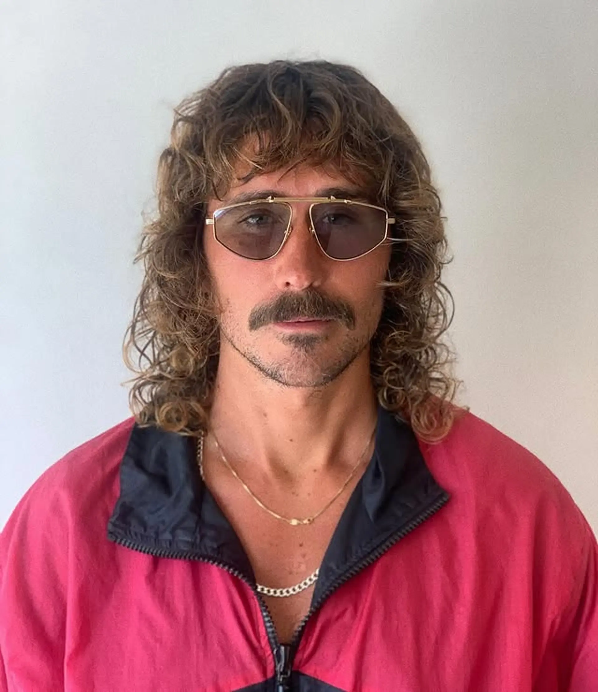 A curly permed mullet with layered texture. 1