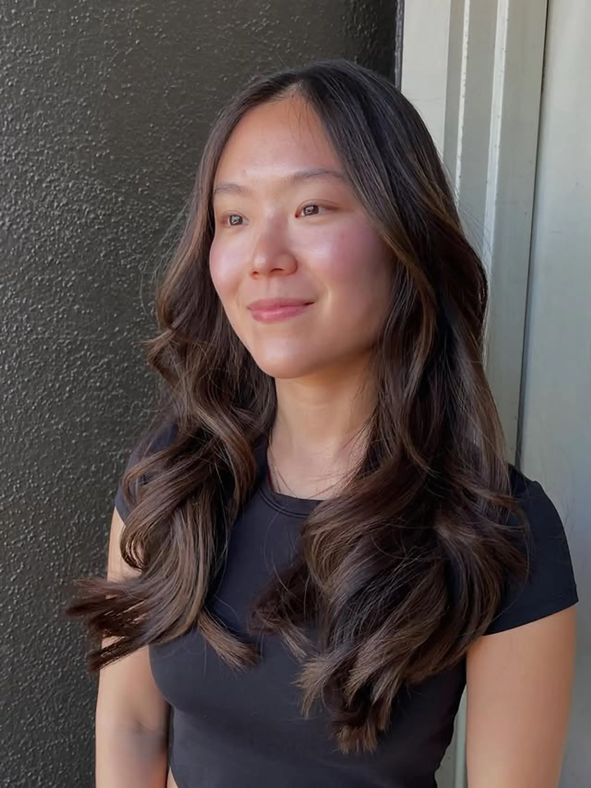Long, wavy hair with a brunette balayage and subtle layers for added movement and dimension. 1