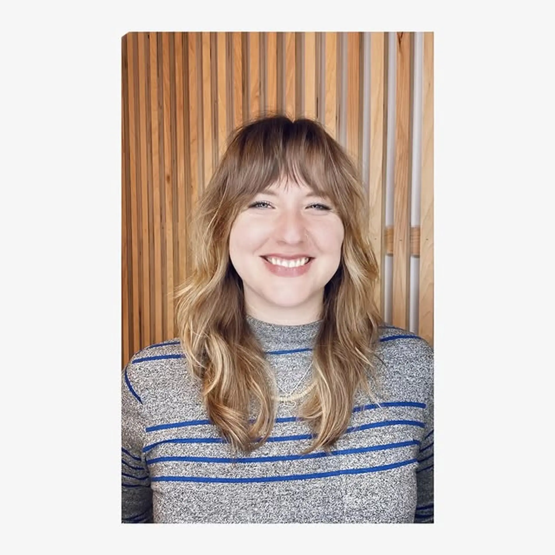 A modern shag haircut featuring textured layers and stylish curtain bangs. 1