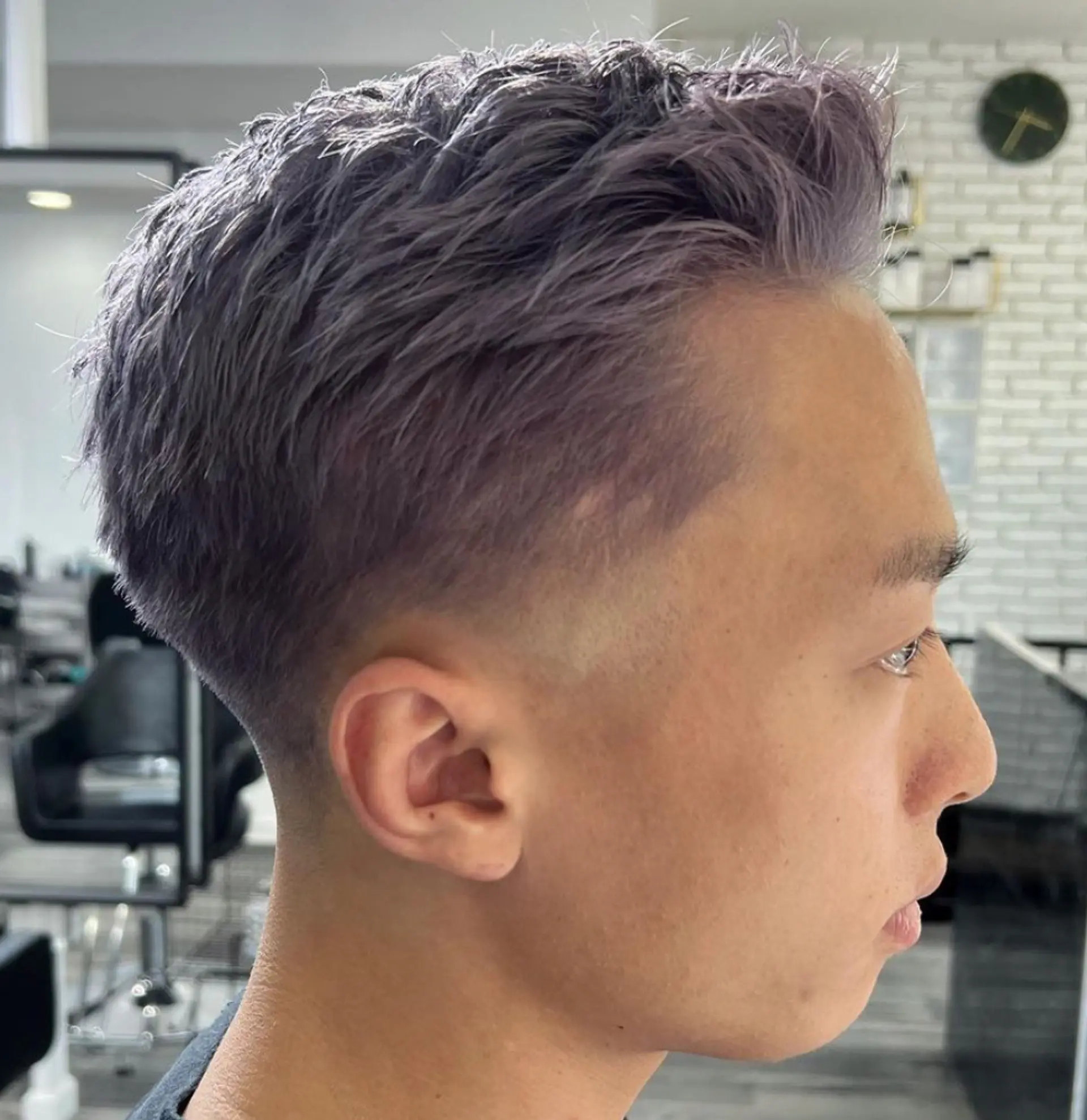 High fade with a textured top, lavender and silver hues, modern and stylish. 1