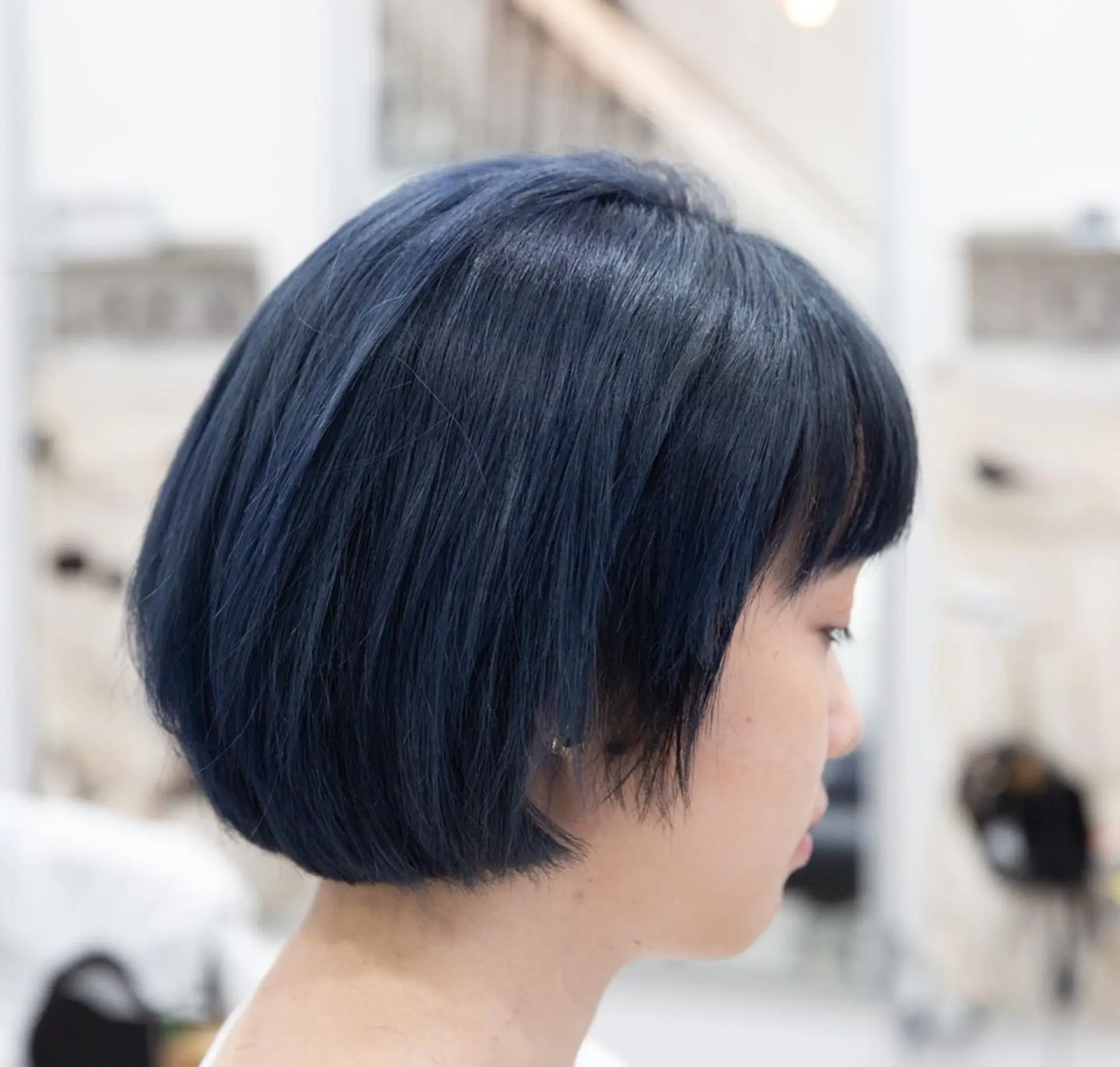A sleek and straight dark blue bob cut with blunt bangs, falling just above the shoulders. 1
