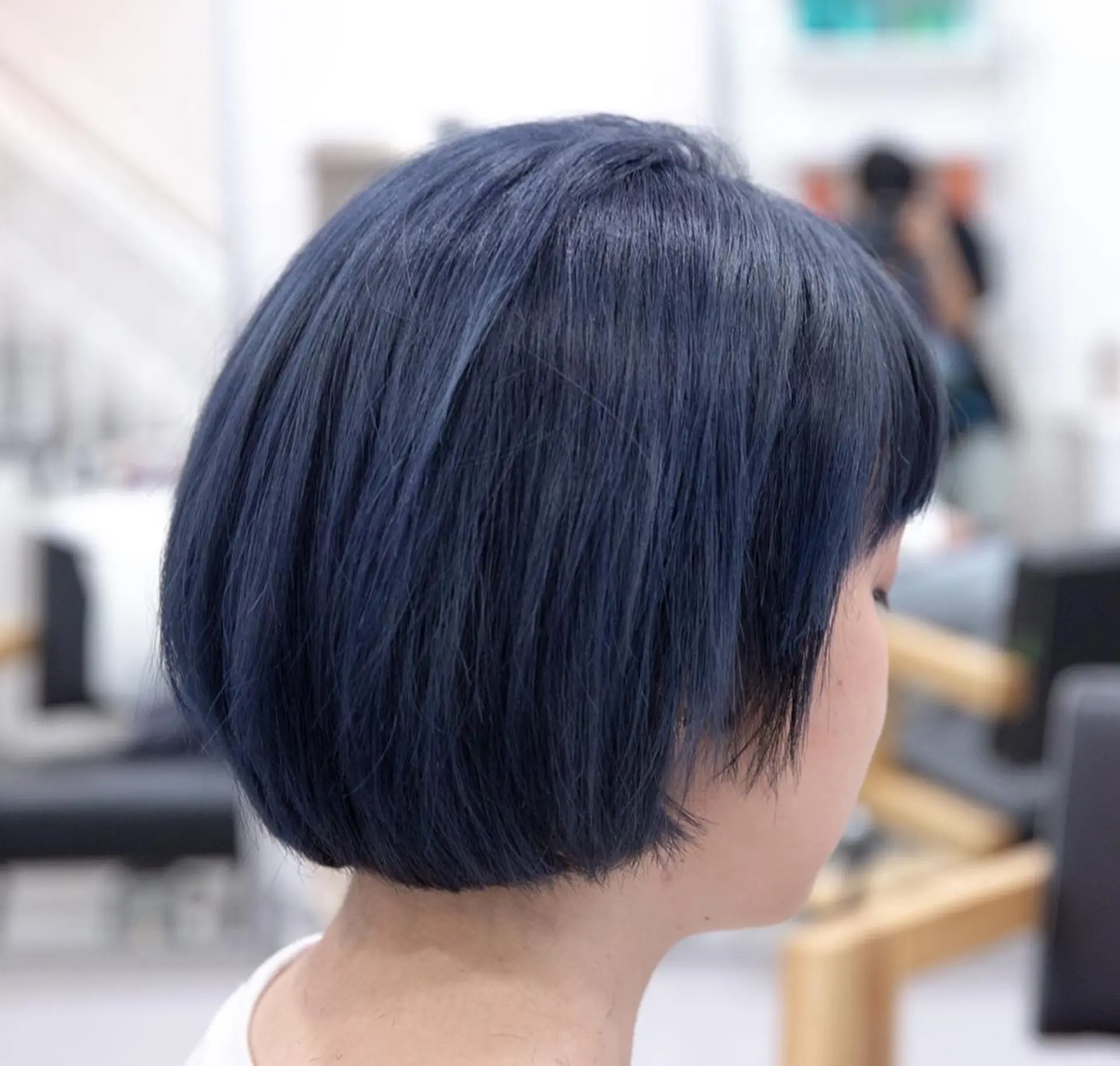A sleek and straight dark blue bob cut with blunt bangs, falling just above the shoulders. 2