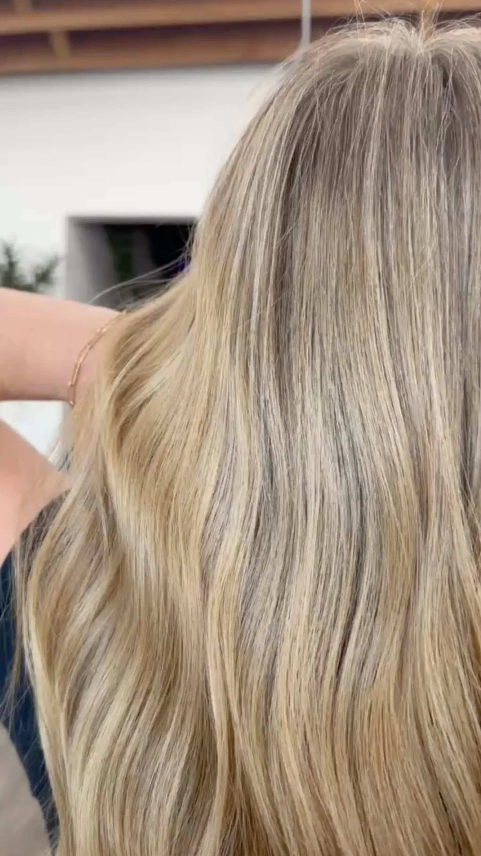 Long dimensional blonde hair styled straight with a smooth, glossy finish. 1