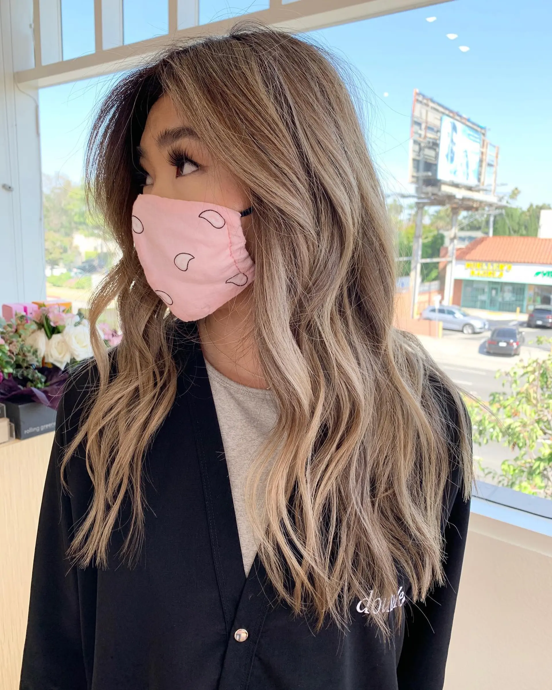 Long dimensional ash blonde balayage styled in soft, loose waves. 1