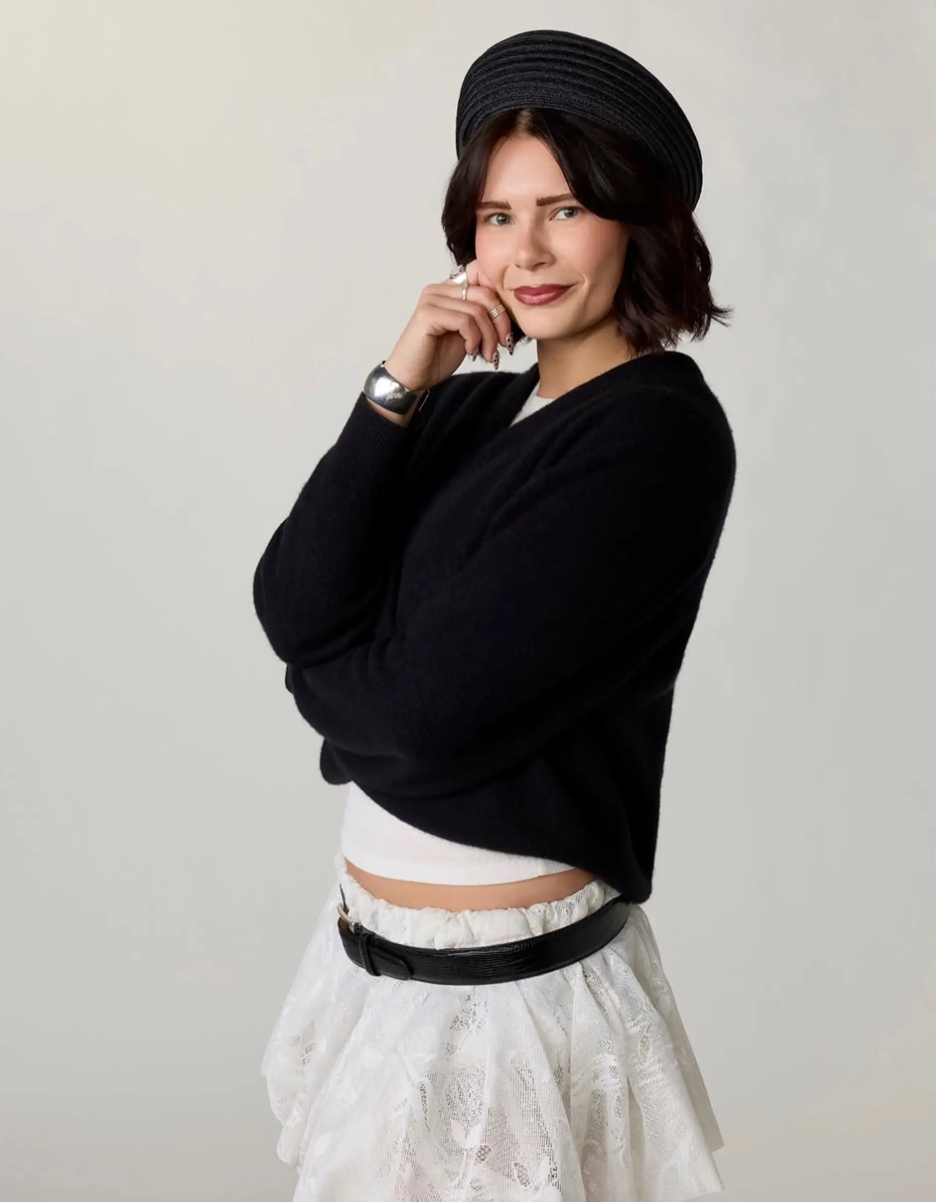 A dark brown textured chin-length bob with soft waves and curtain bangs framing the face. 1