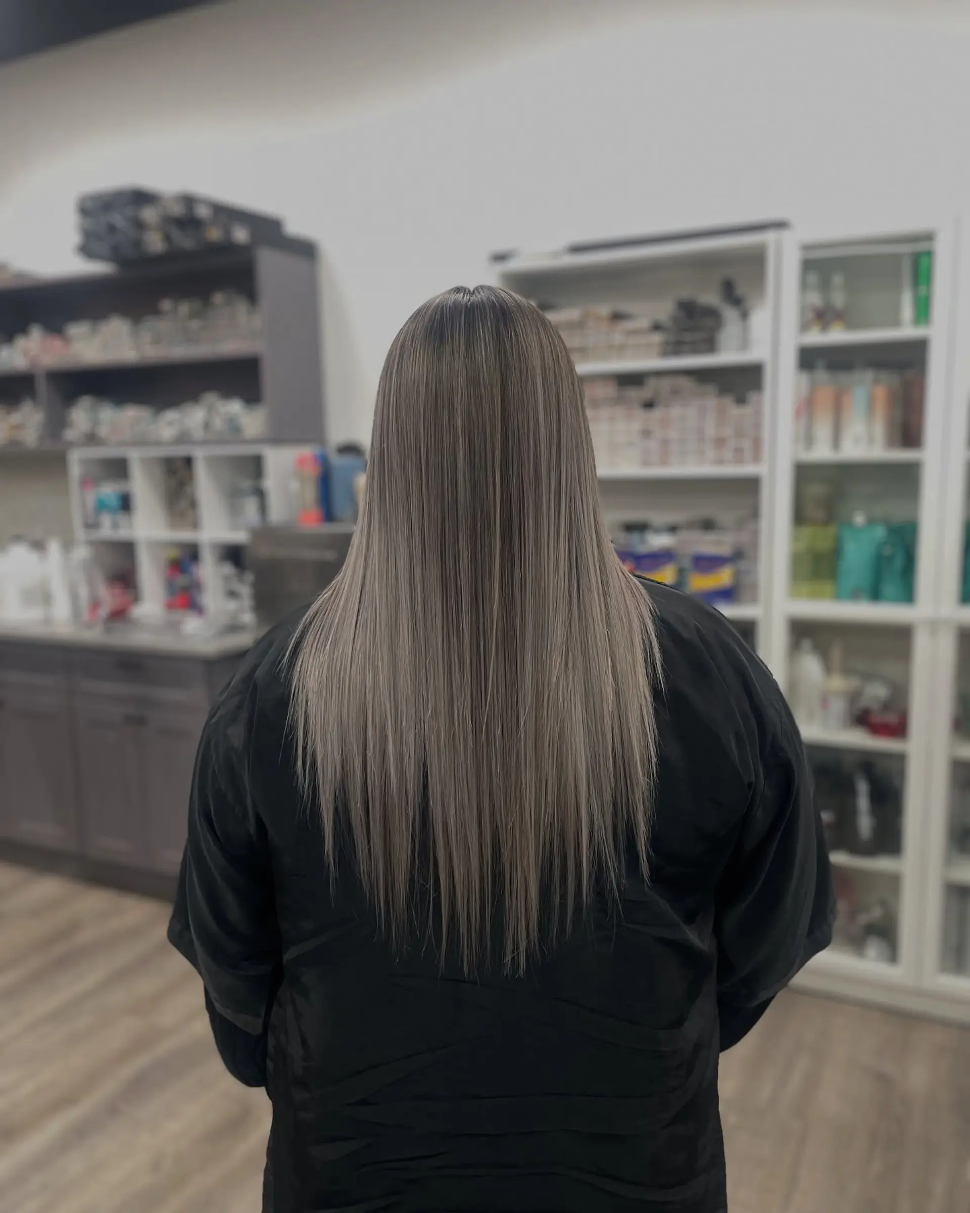 Long, straight hair with subtle layers and an ash blonde color. 1
