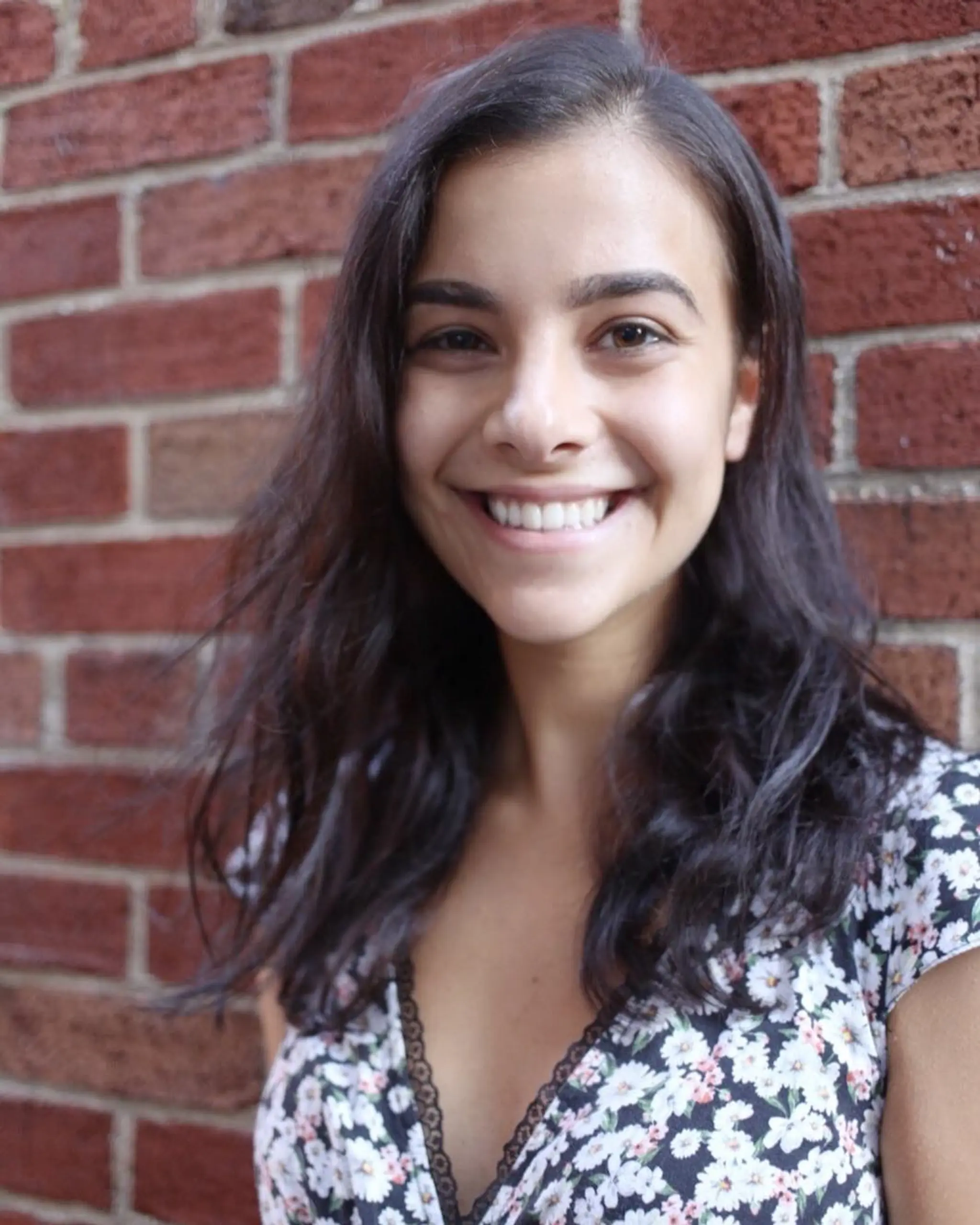 Medium-length, wavy, dark brown hair flowing naturally around the shoulders with a soft, relaxed texture, perfect for a casual, everyday look.