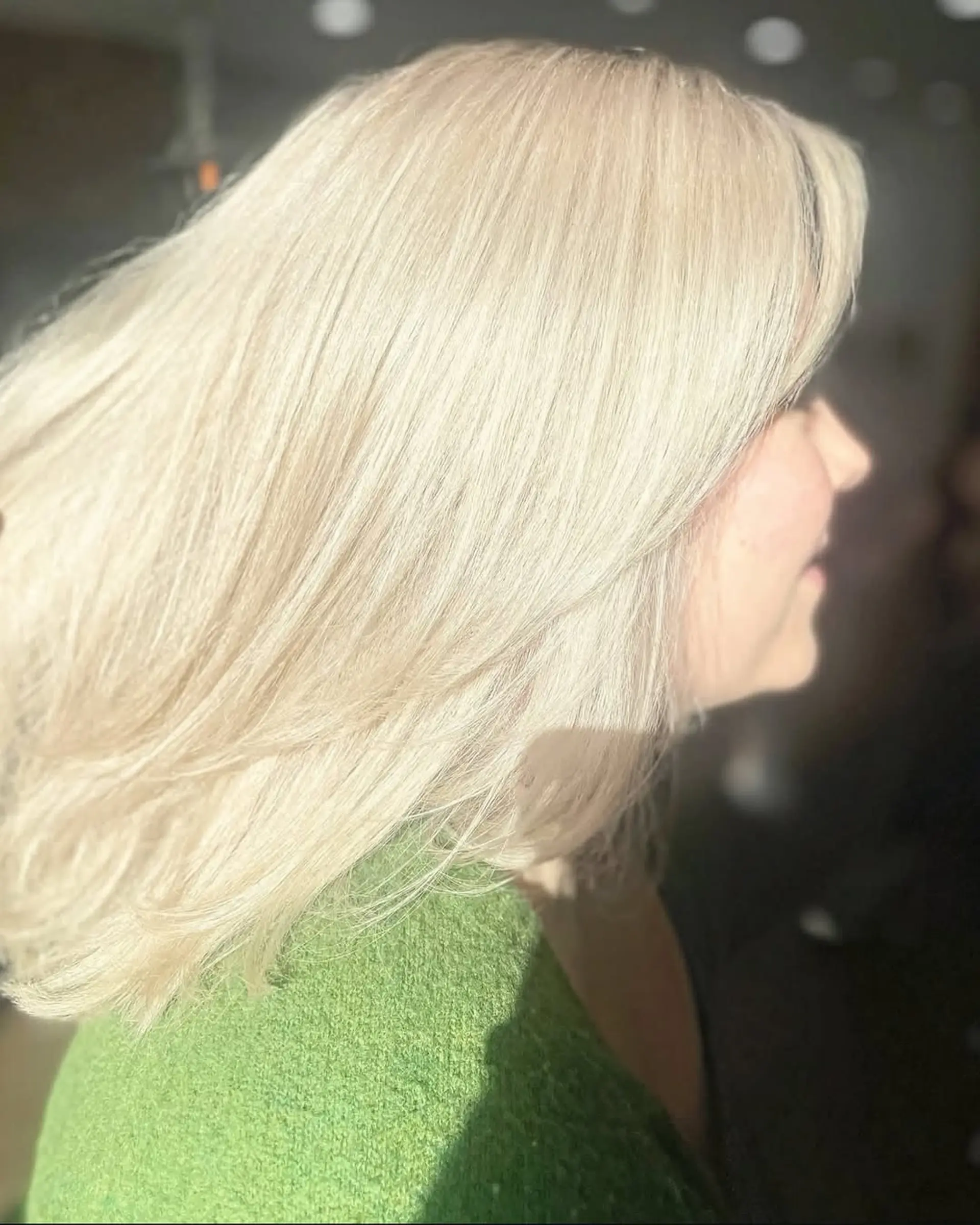 A chic medium-length haircut featuring soft layers that create volume and movement, styled with a smooth and voluminous blowout. The cut enhances body and provides a polished finish. 3