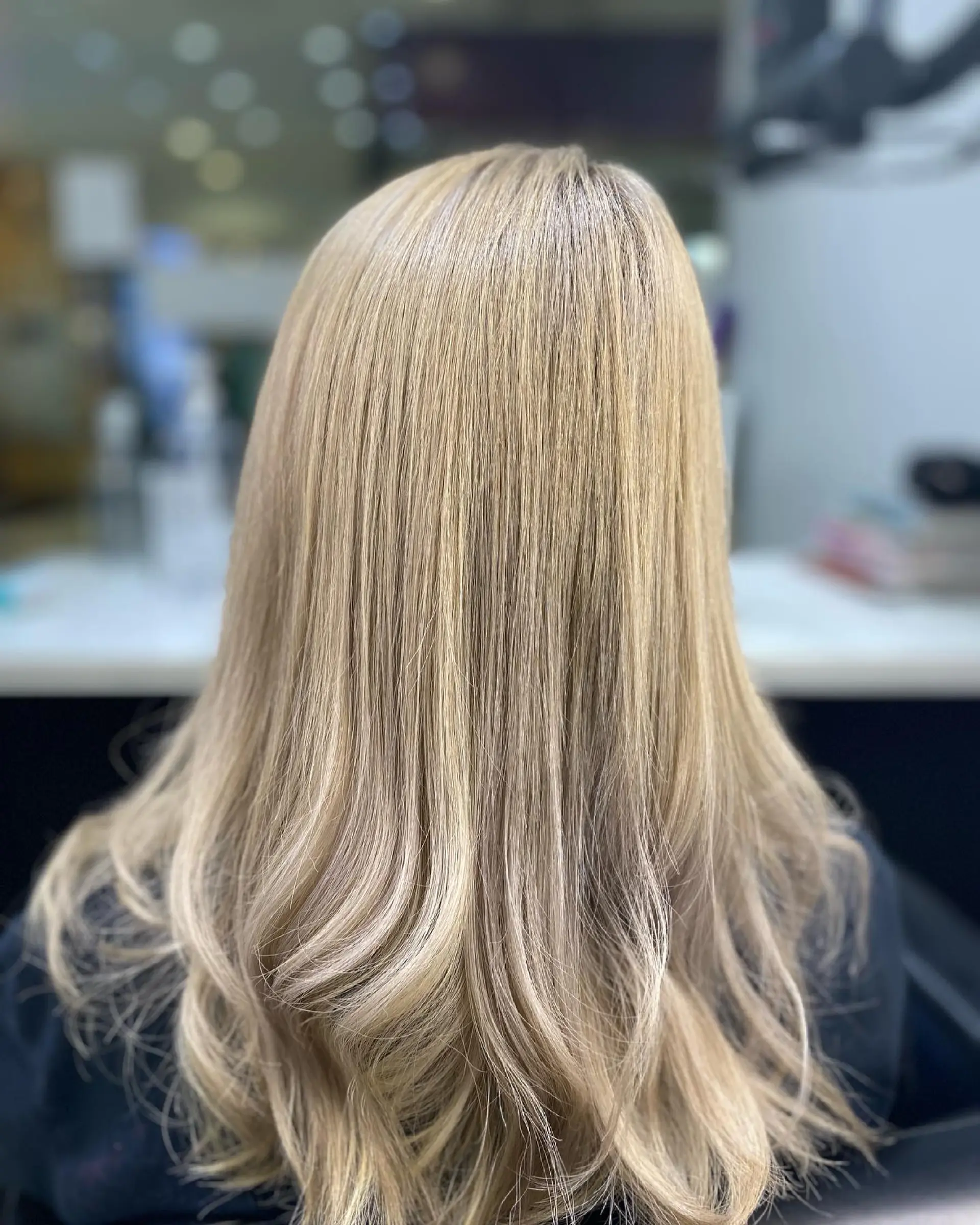 Long, straight hair with a light brown to blonde balayage that creates a dimensional and beachy effect. 2