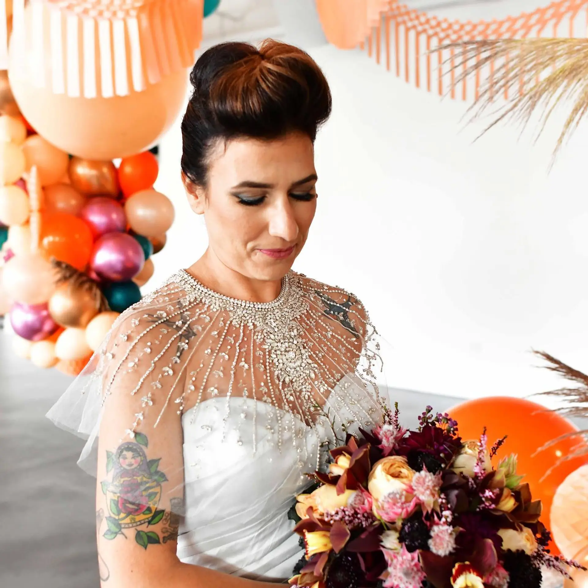 A vintage-inspired bridal updo featuring a sculpted, voluminous rolled pompadour at the crown. 1