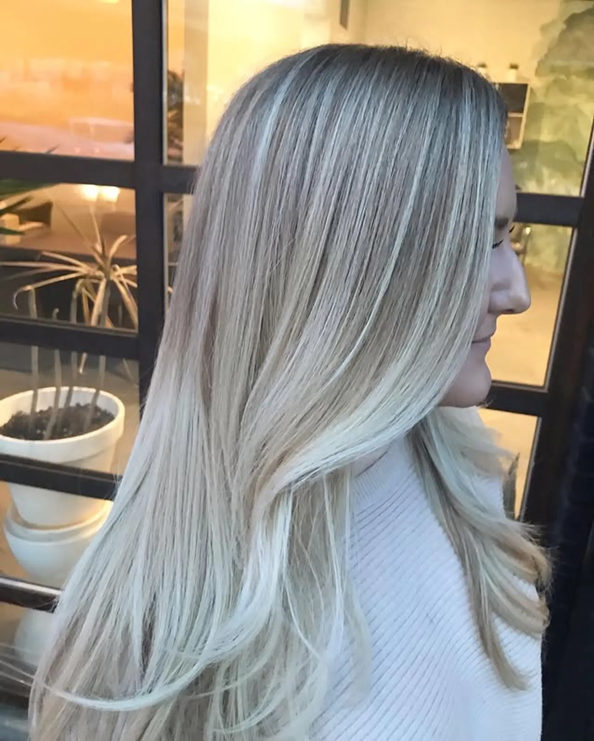 Long, layered hairstyle with a beautiful icy blonde balayage. 1