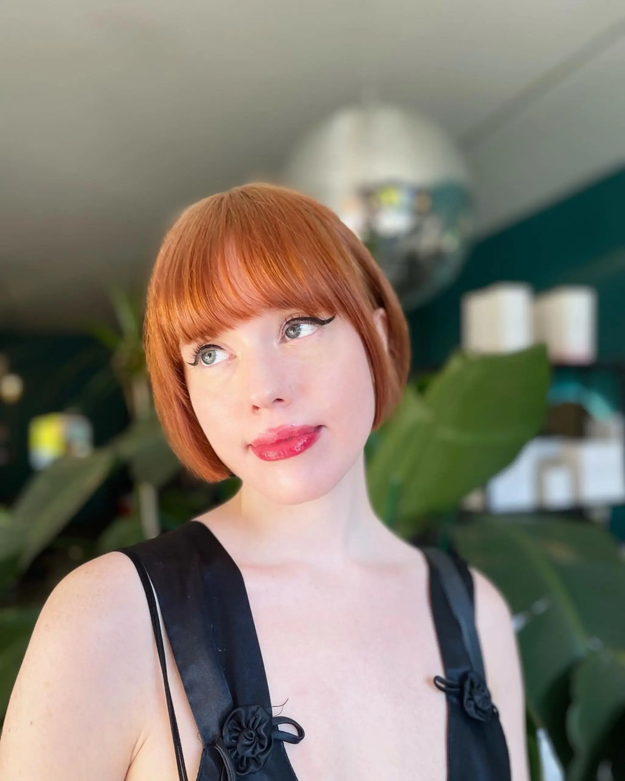 Chic auburn bob with straight, short hair featuring fringe bangs and a sleek, warm-toned finish. 1