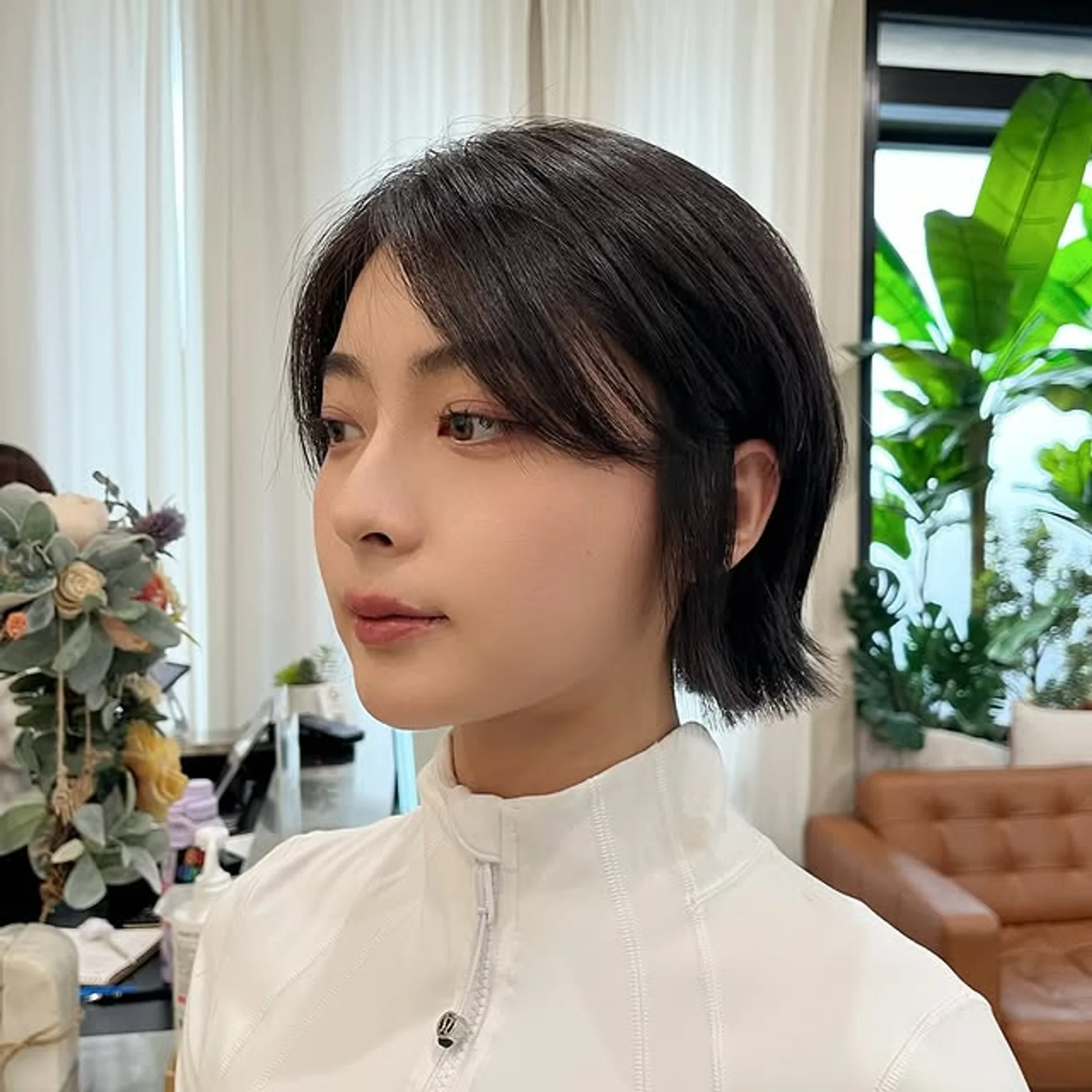 Chic short bob haircut with soft wispy Birkin bangs and subtle face-framing layers - Preview 3