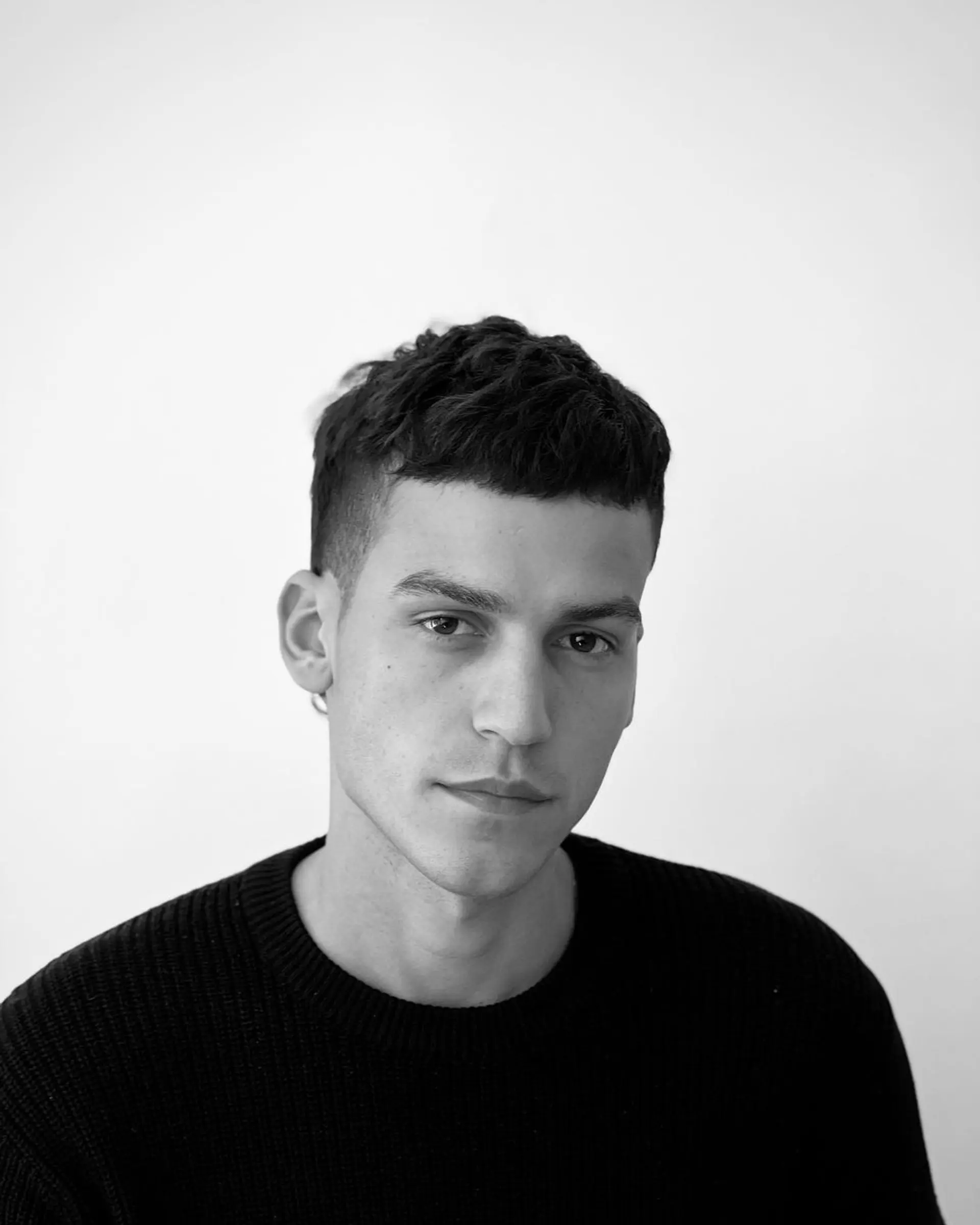 Short, straight dark brown hair with a textured top and a neat, tapered fringe. 1