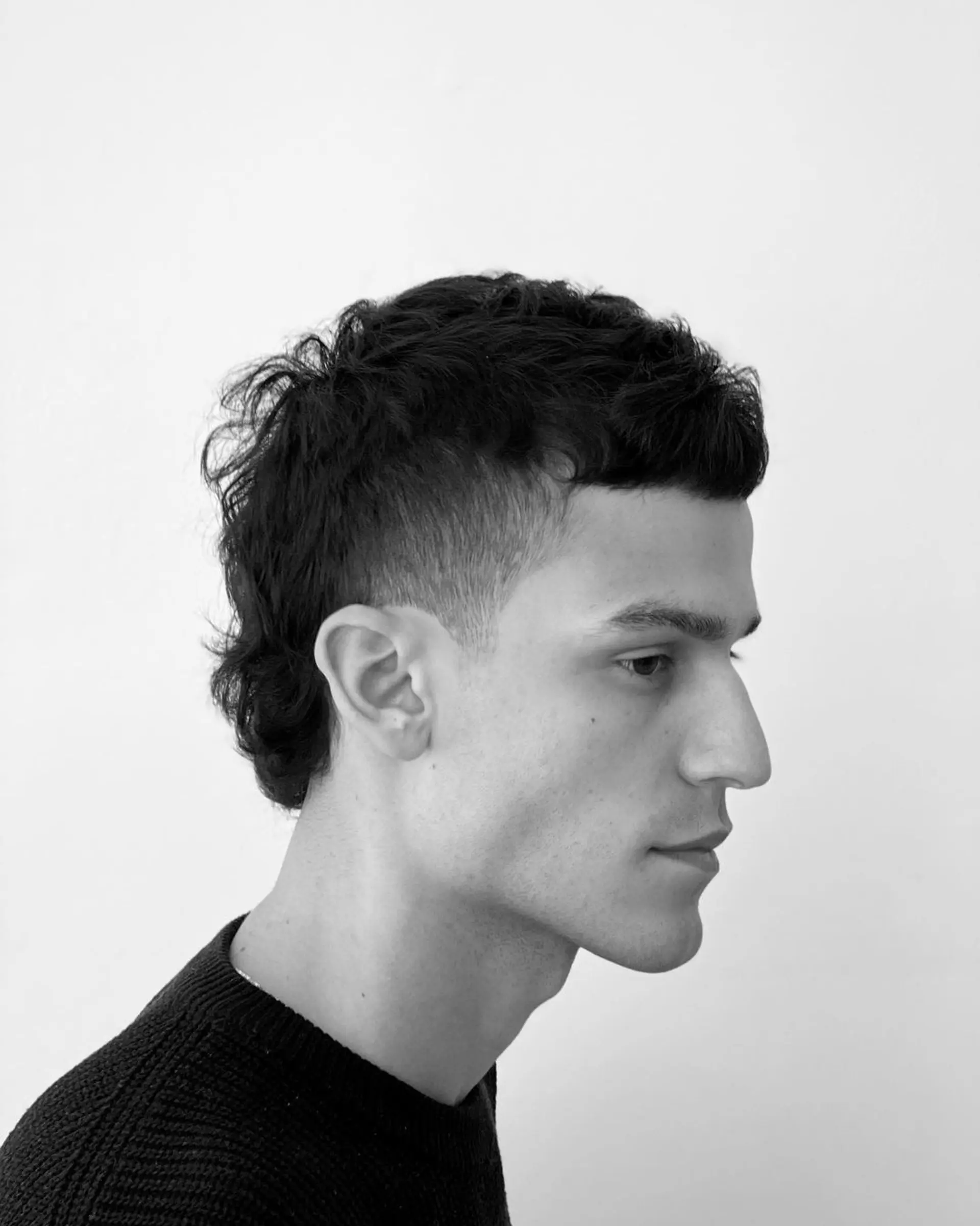 Short, straight dark brown hair with a textured top and a neat, tapered fringe. 2