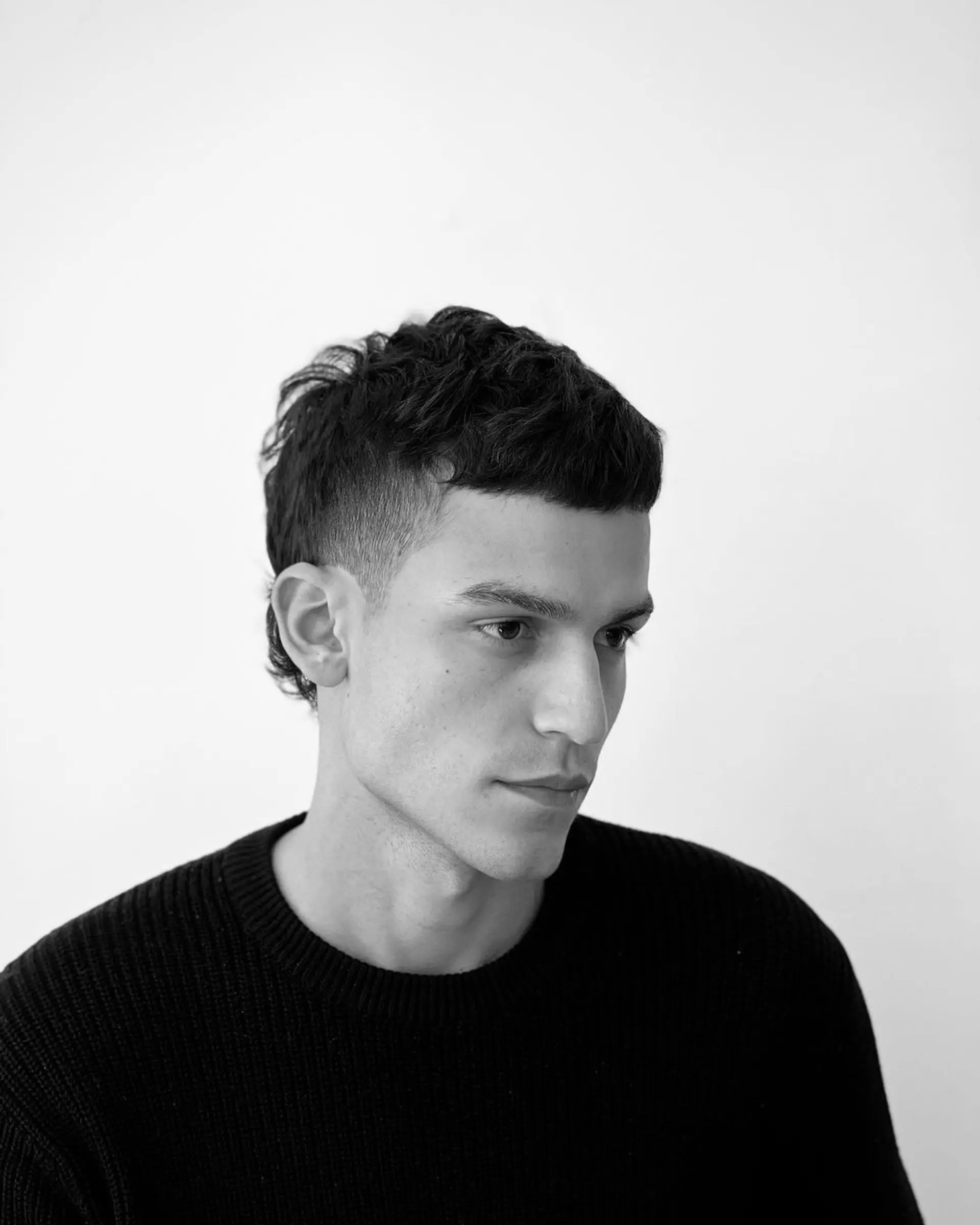 Short, straight dark brown hair with a textured top and a neat, tapered fringe. 3