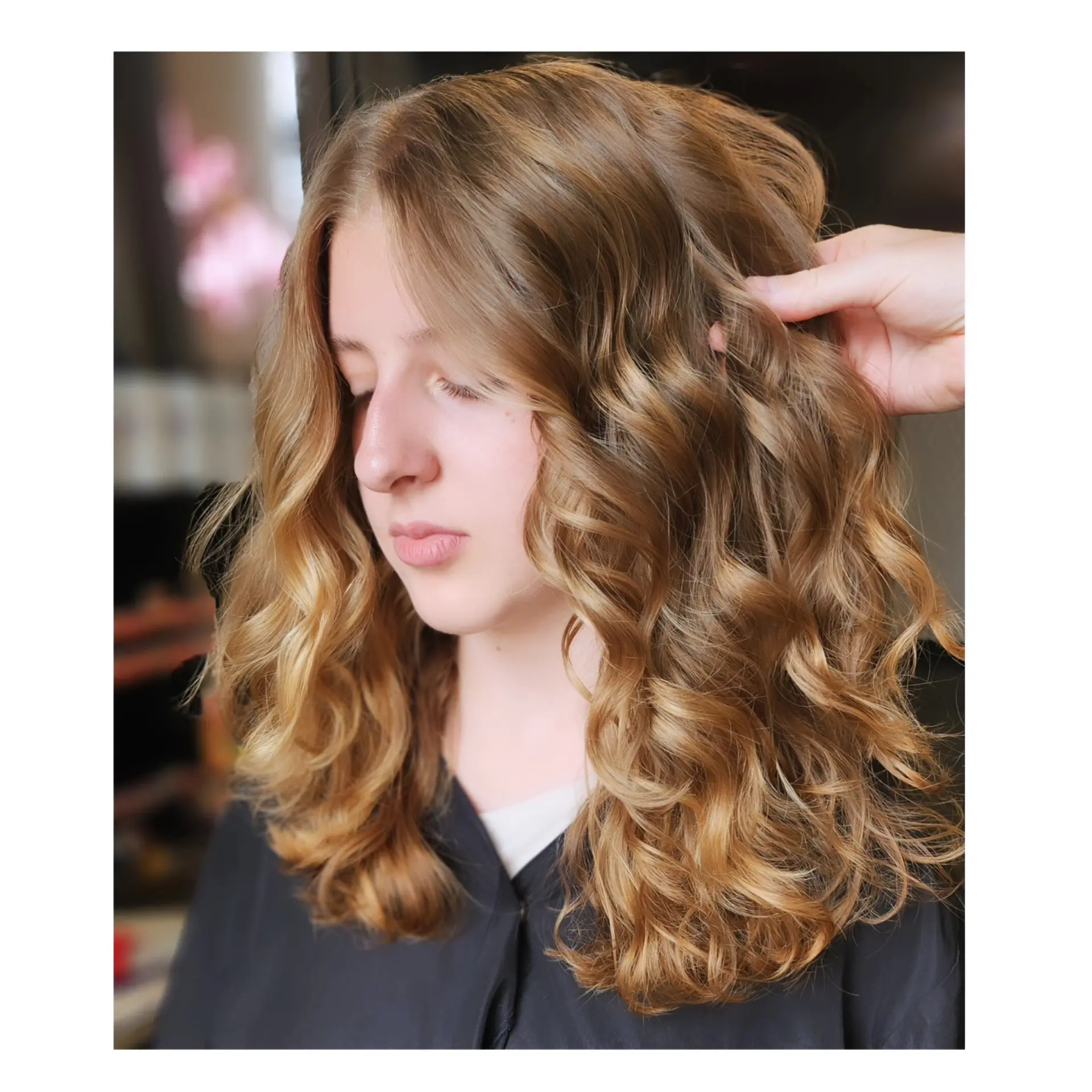 Medium-length golden brown hair styled into glossy, defined bouncy curls with face-framing layers. 1