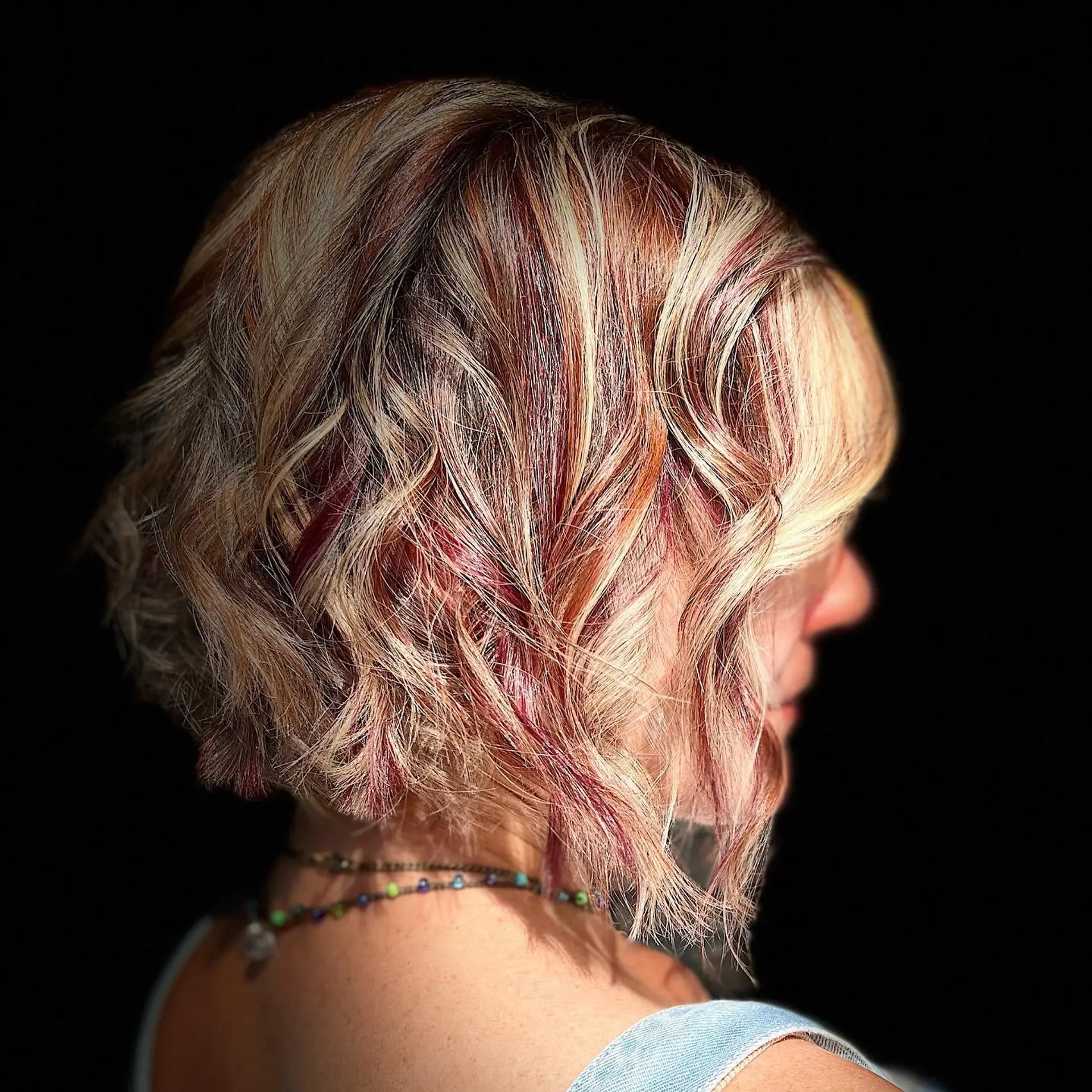 A textured, wavy bob with vibrant dimensional highlights. 1
