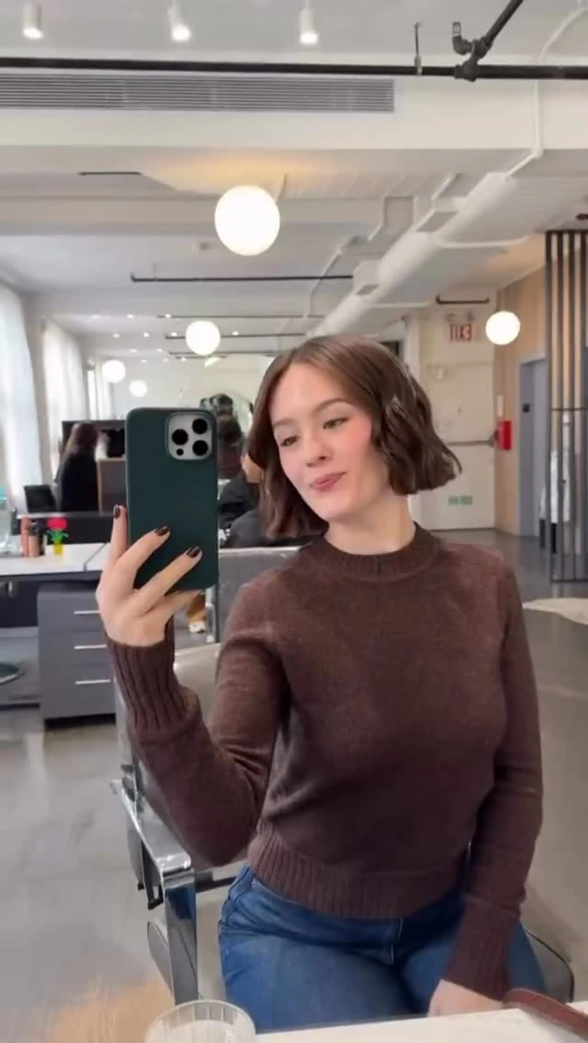 A chic chin-length short bob styled with soft, subtle waves and a center part. 1
