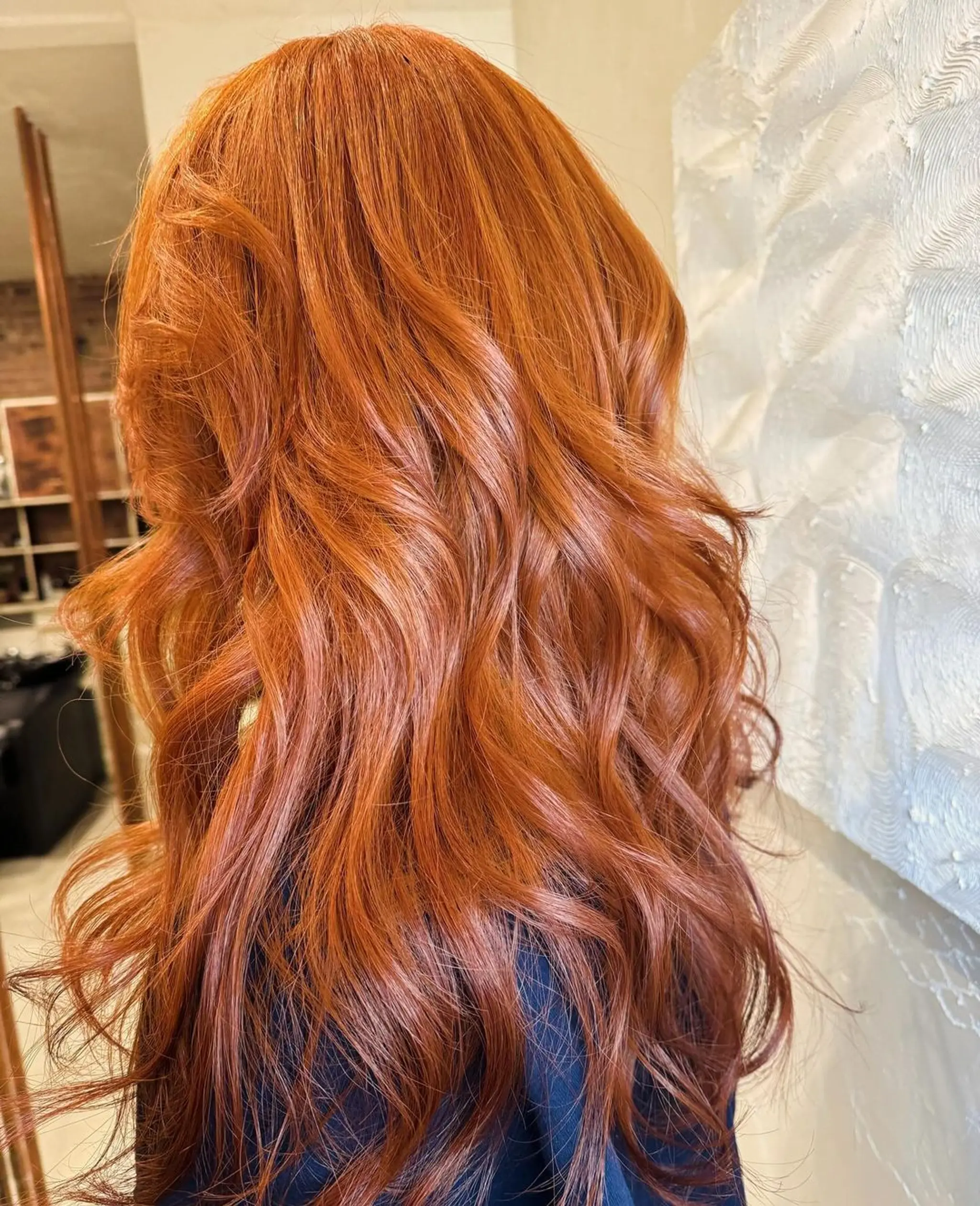 Long, wavy copper-red hair with loose, voluminous waves and a healthy shine. 1