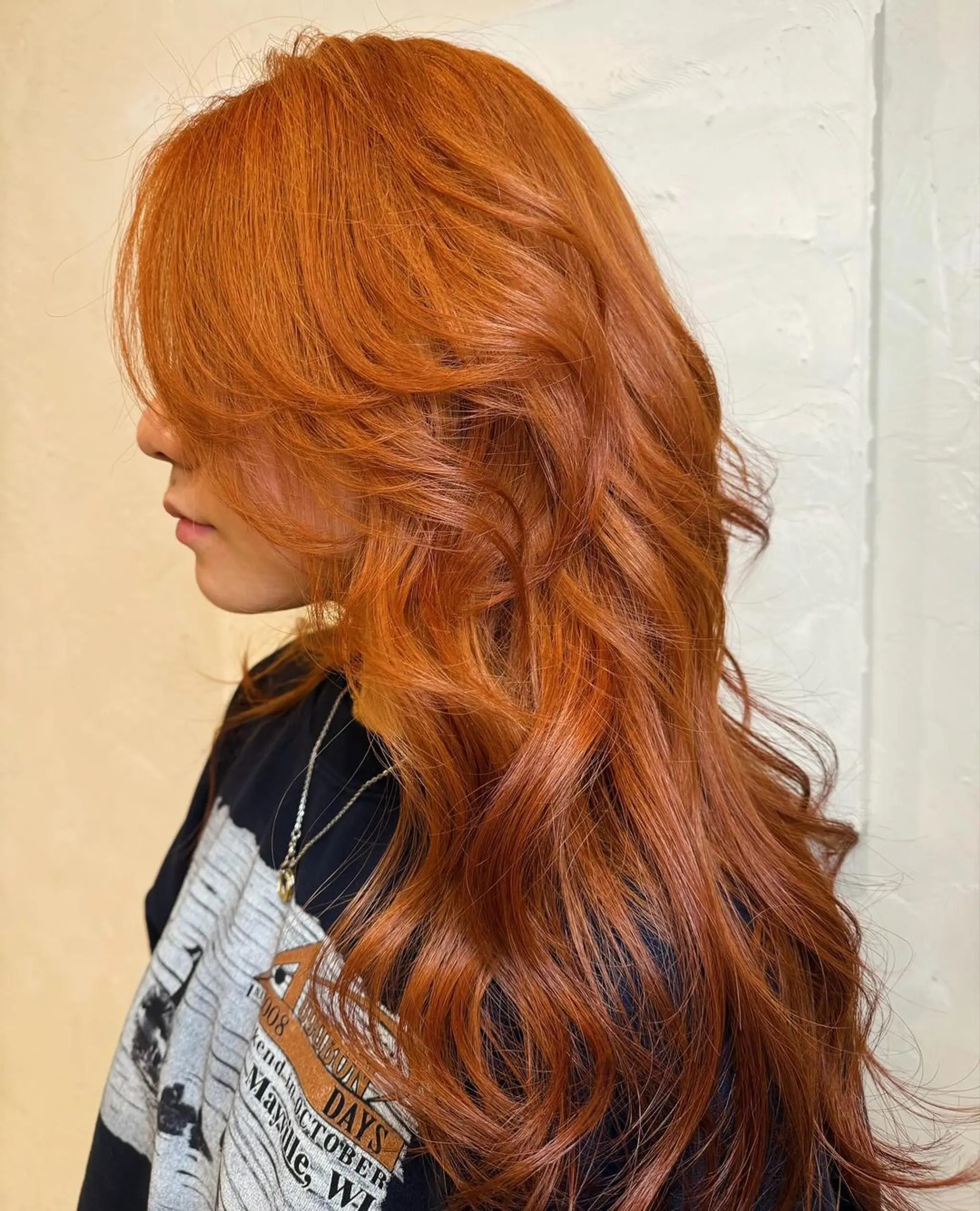 Long, wavy copper-red hair with loose, voluminous waves and a healthy shine. 2