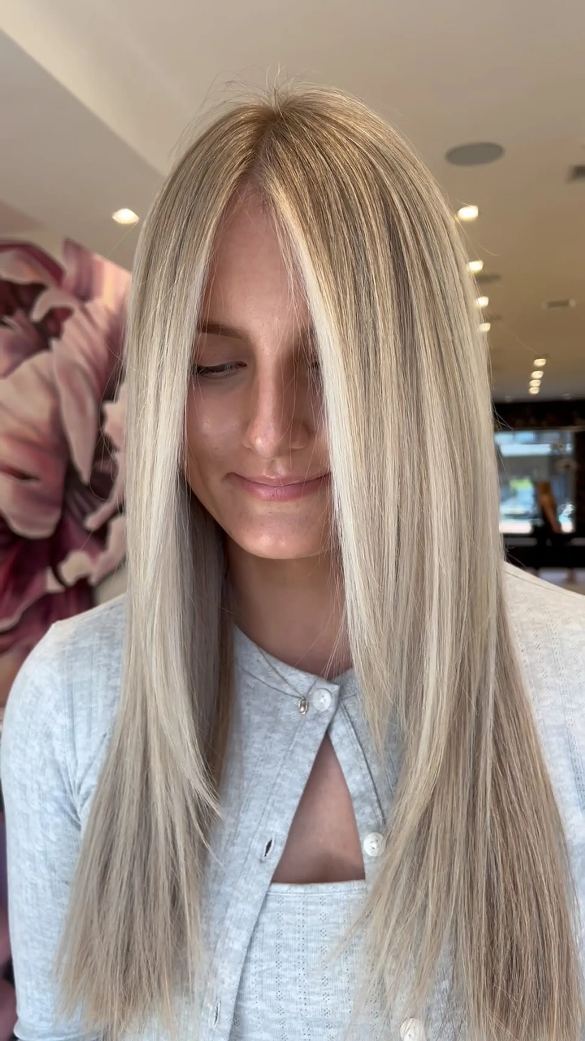 Long, sleek straight blonde hair with seamless dimensional balayage highlights and face-framing layers. 1